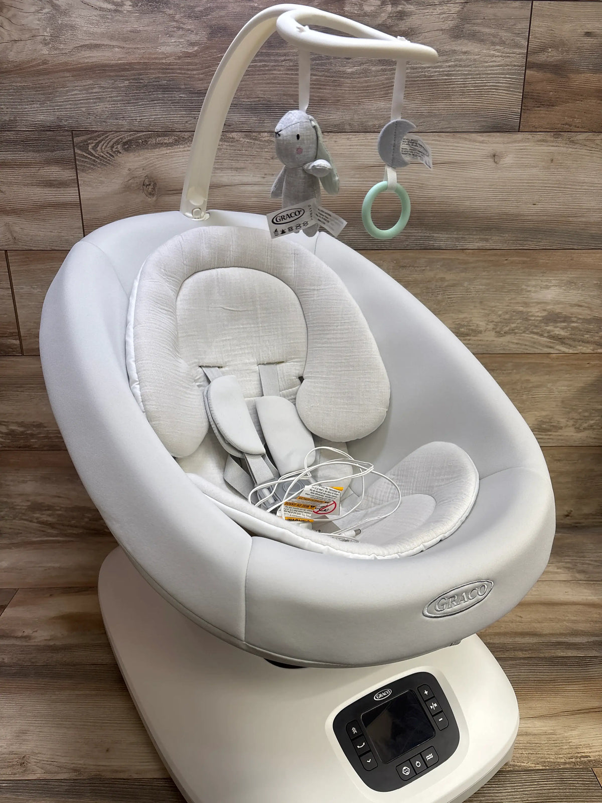 Front view of Graco Smart Sense Soothing Baby Swing Rori showcasing padded seat, harness, toys, and control panel
