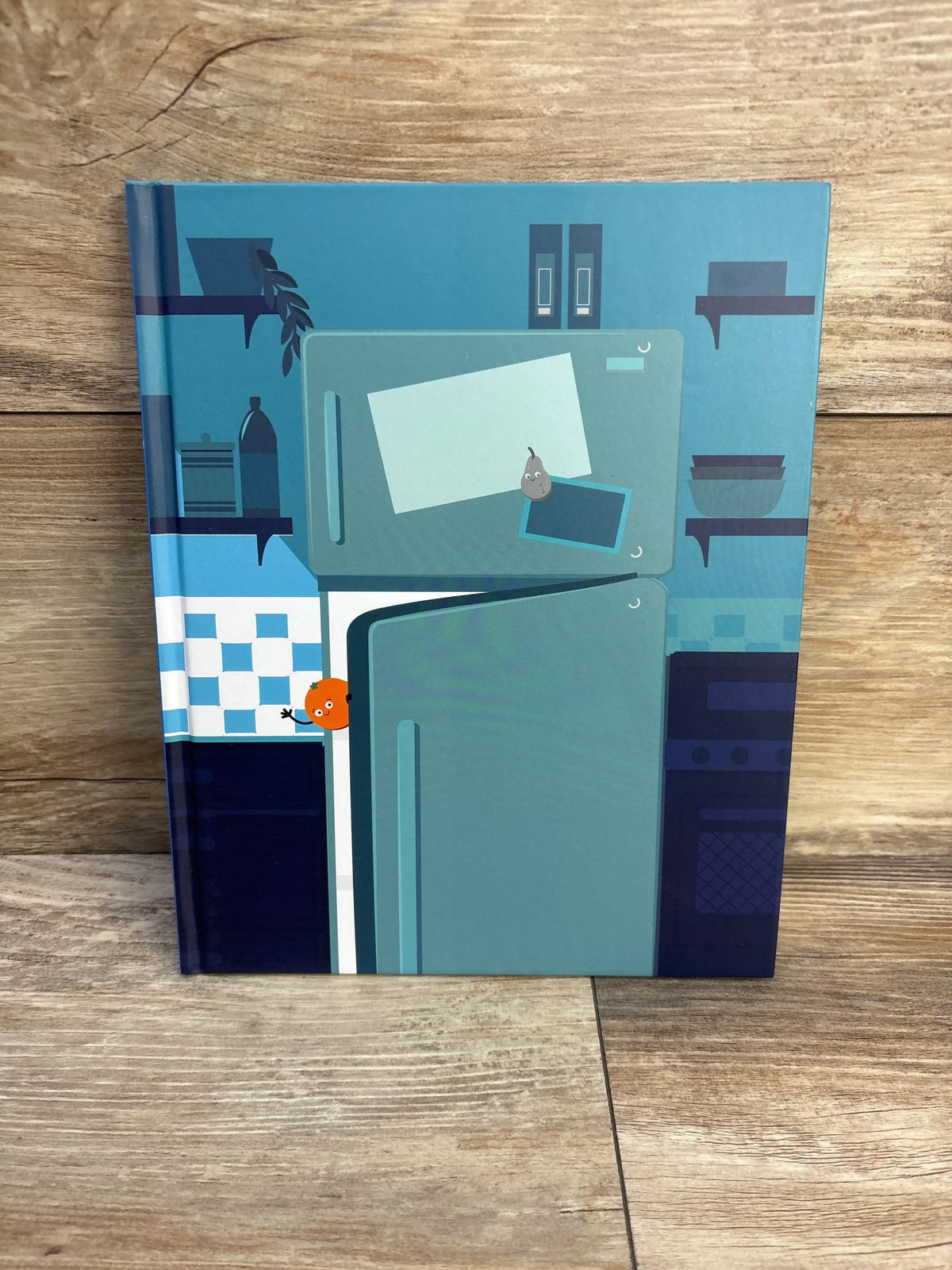 Front cover of Harold the Iceberg Melts Down hardcover book with a blue kitchen illustration, food characters, and refrigerator