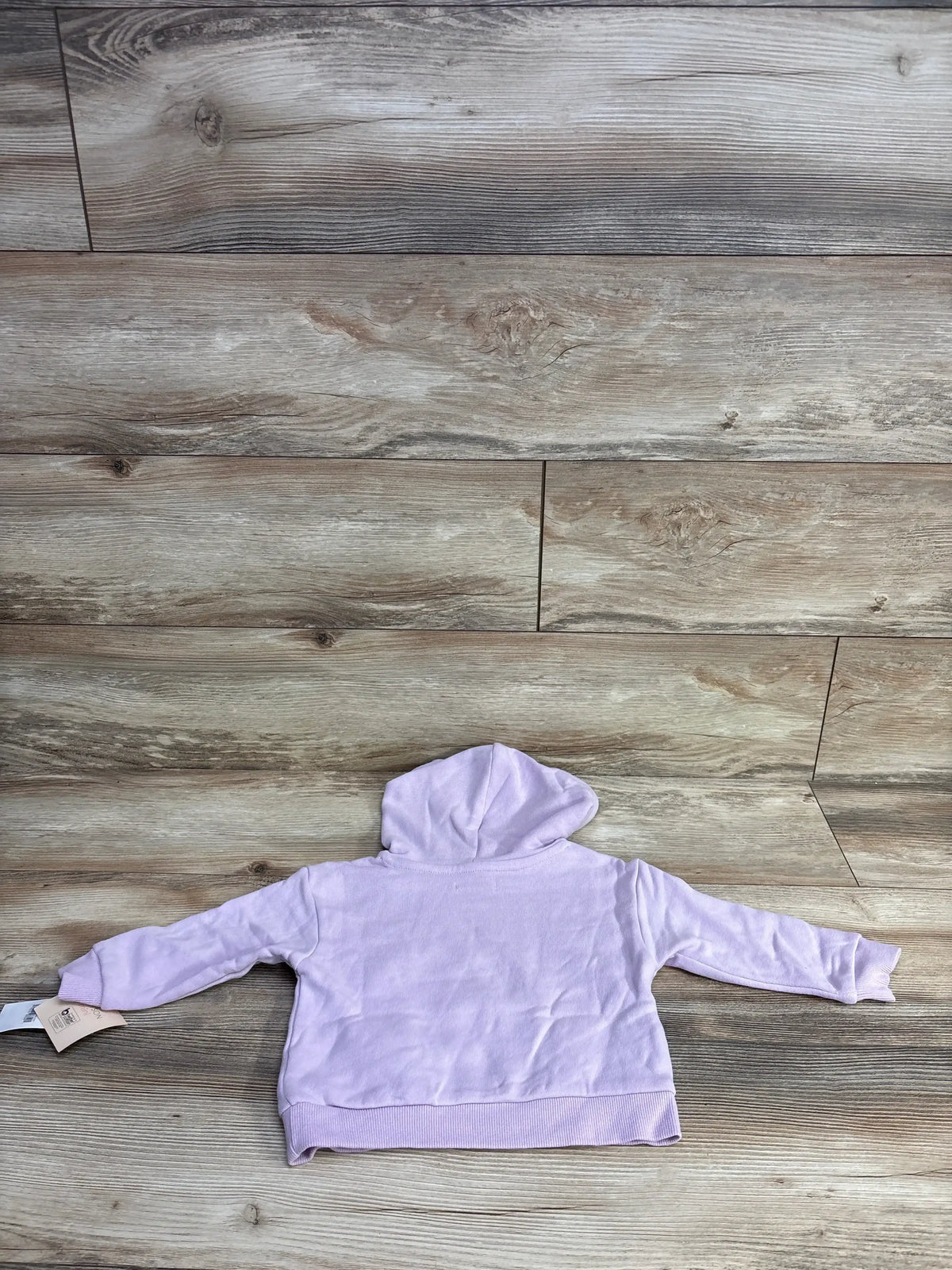 Light purple baby hoodie sweatshirt laid flat on wood background, long sleeves, resale clothing