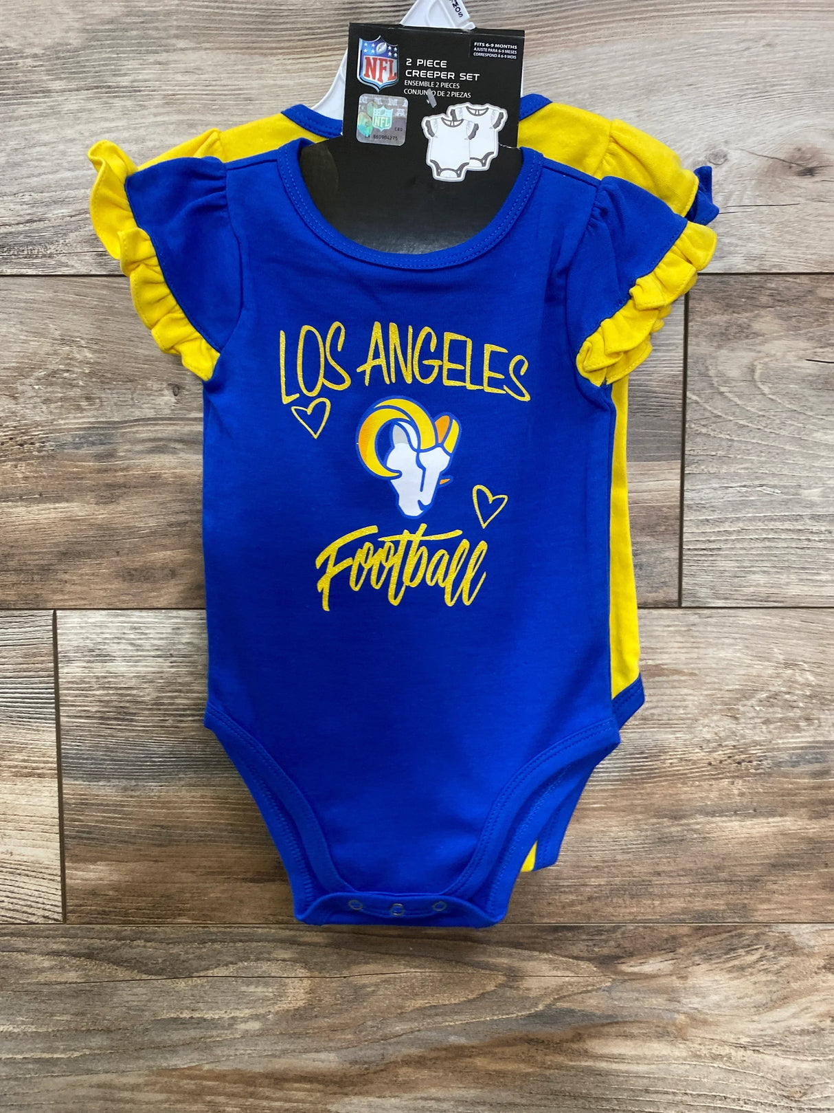 Los Angeles football baby bodysuit set in blue and yellow with team logo on wood background