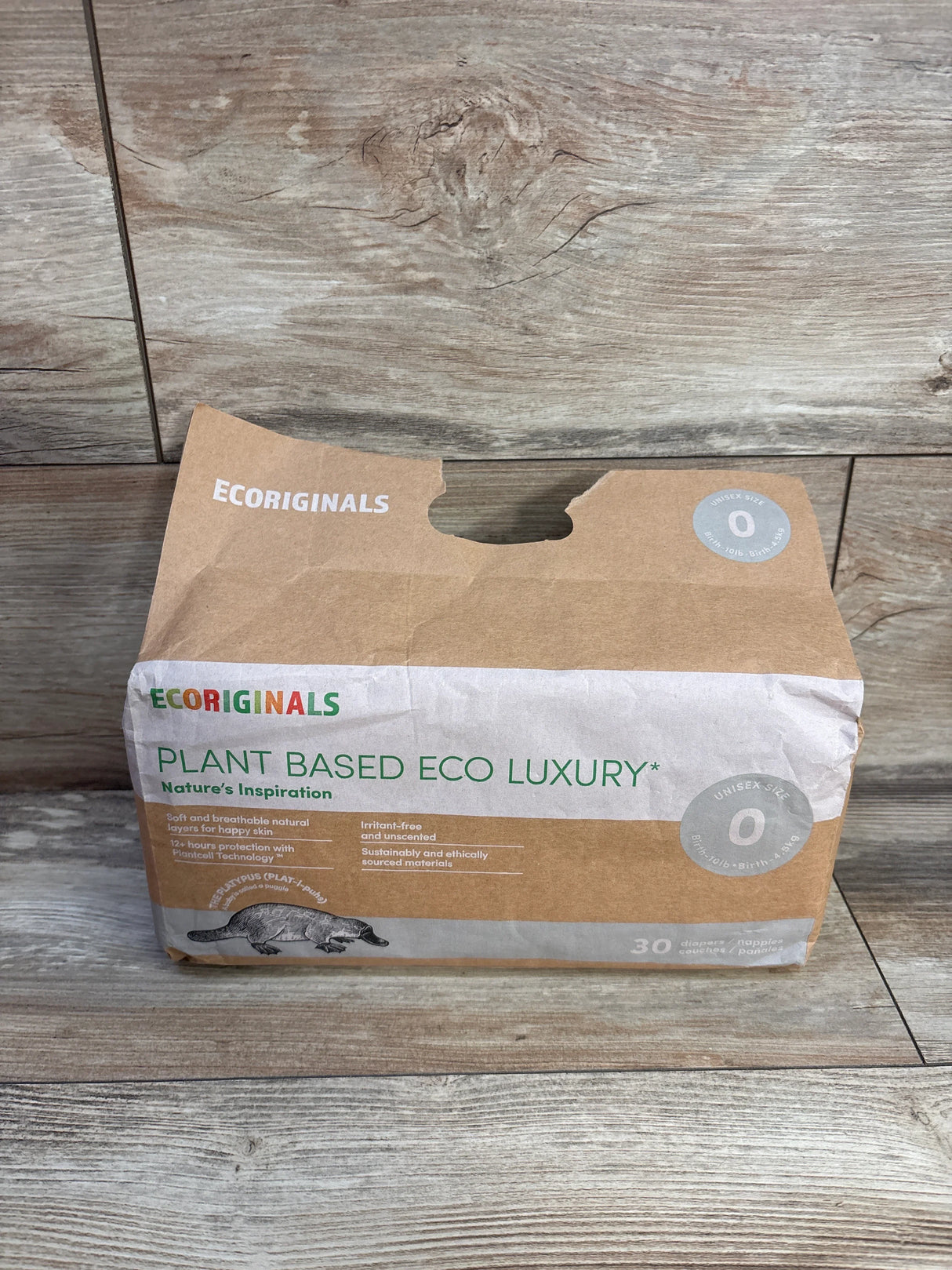 Ecoriginals plant based eco luxury newborn diapers pack on wood floor