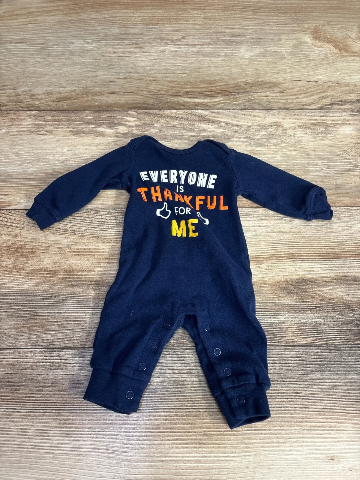 Navy baby onesie with 'Everyone is Thankful for Me' print, long sleeves, snap closures, perfect for Thanksgiving outfits.