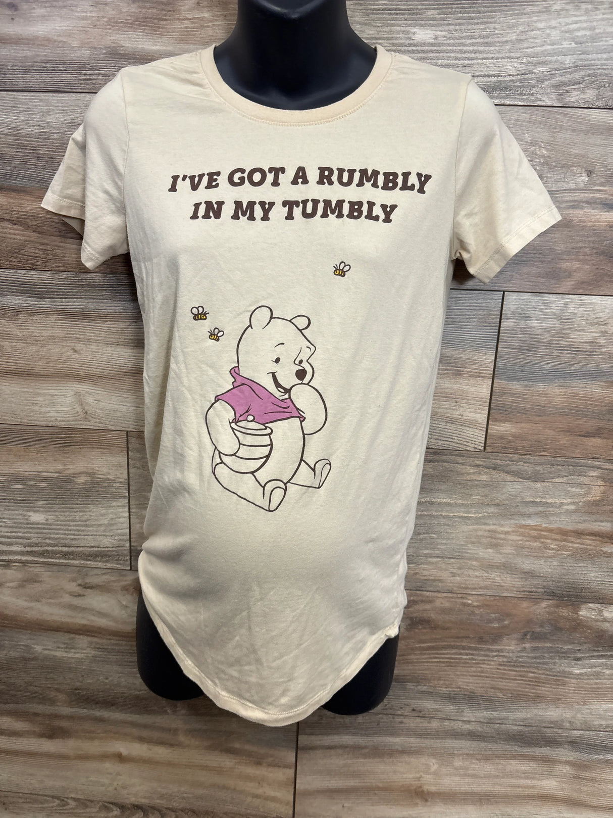 Beige maternity t-shirt with Winnie the Pooh holding honey pot and text 'I've got a rumbly in my tumbly'