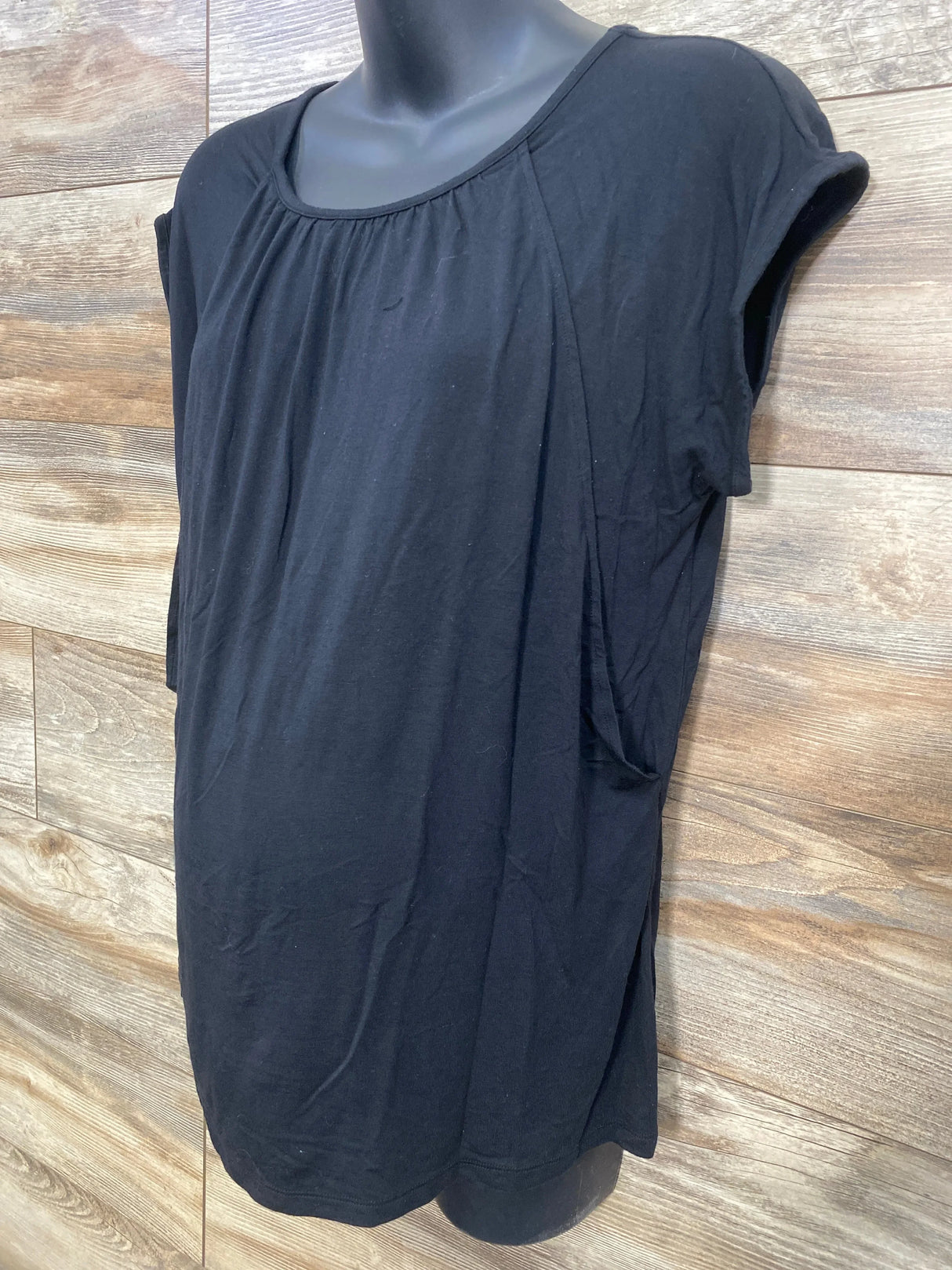 Front view of black Gap maternity nursing shirt with short sleeves, front pleats and side nursing access on mannequin