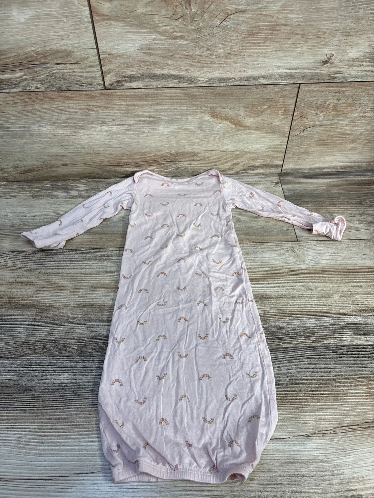 Front view of Carter’s PurelySoft sleep gown in soft pink showcasing rainbow pattern and fold-over cuffs on wood flooring