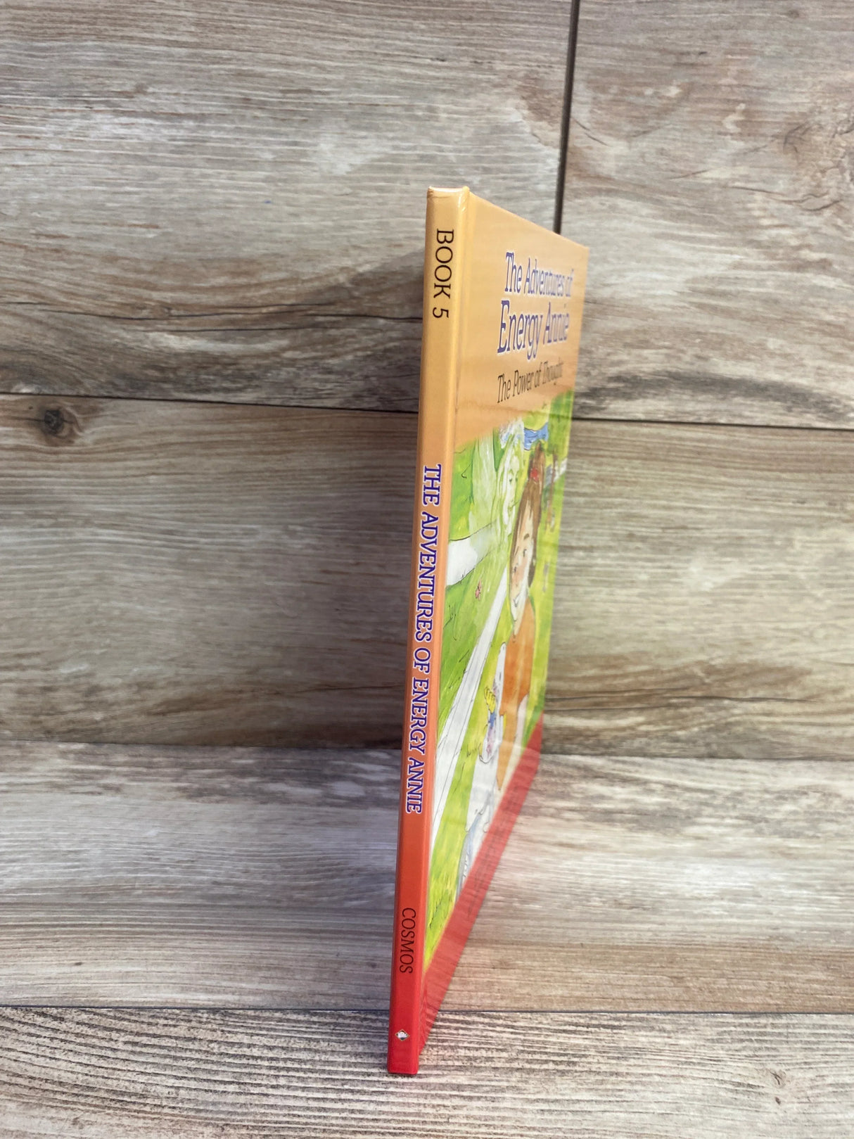 Front cover of The Adventures of Energy Annie hardcover children’s book with colorful illustration of Annie and title on white background