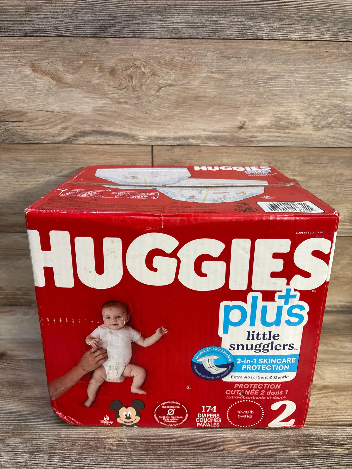 Front view of Huggies Plus Little Snugglers Size 2 diaper box showing 174 diapers for 12 to 18 lb babies