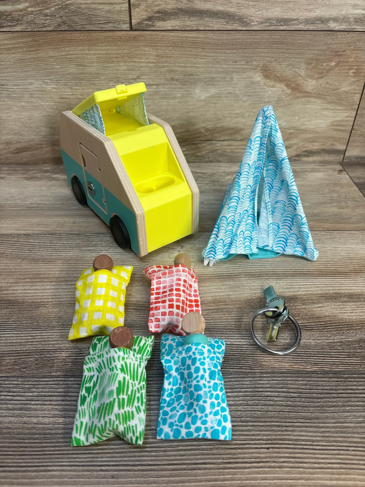 Wooden camper van toy with fabric dolls, tent, and keys for kids' imaginative play
