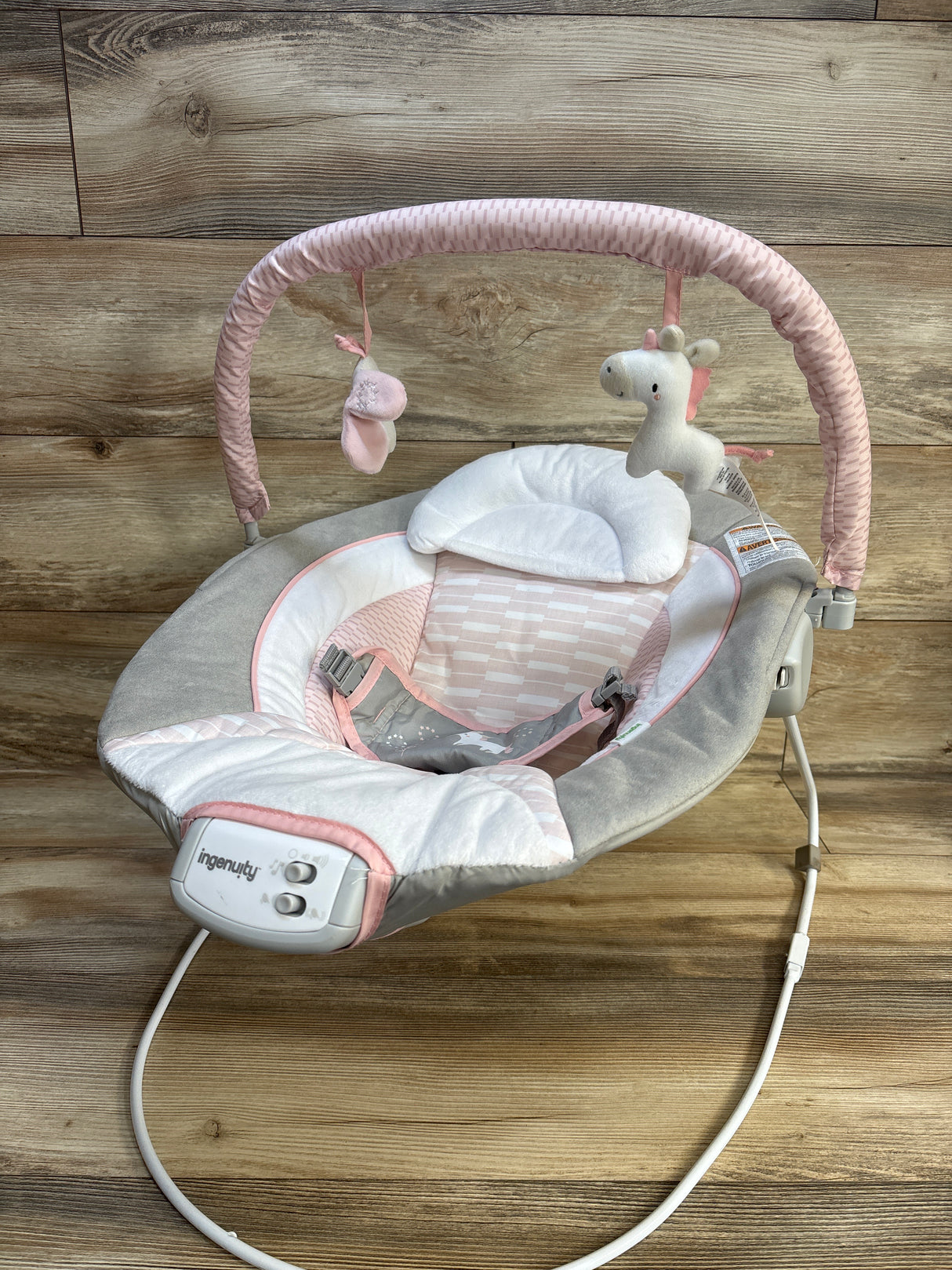 Pink and gray Ingenuity baby swing with unicorn toy, perfect for newborns and infants