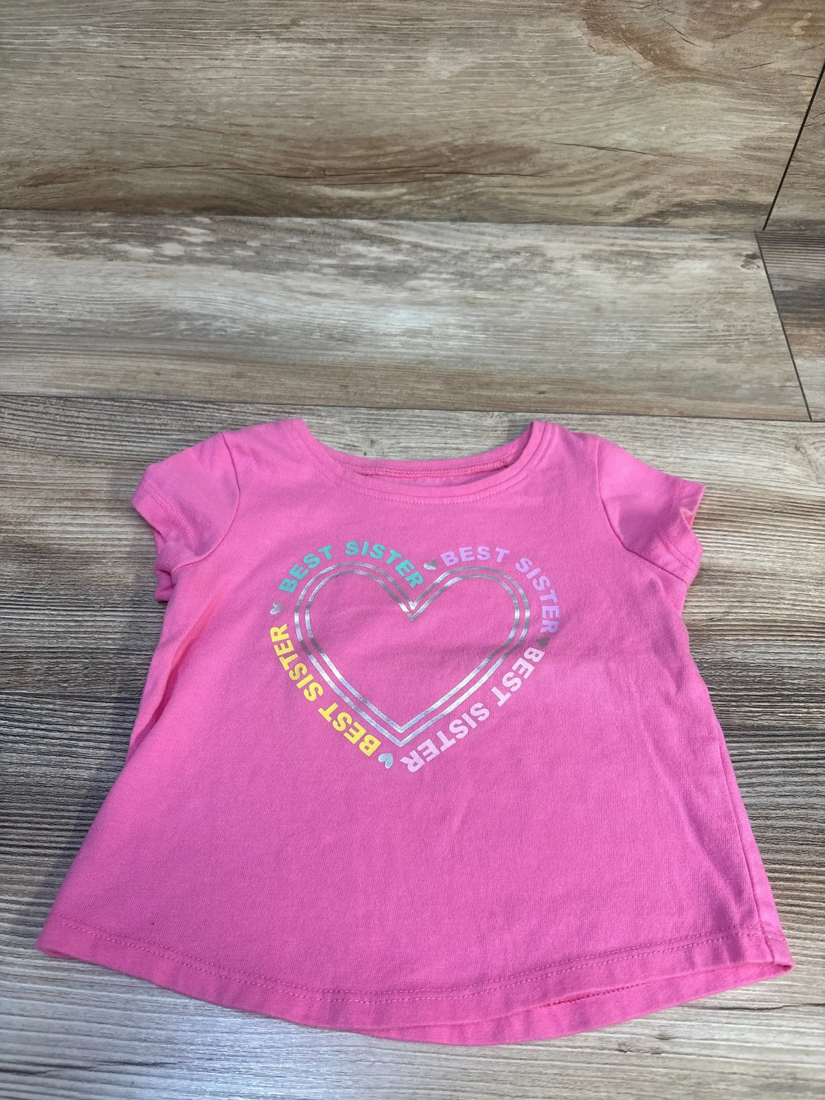 Front view of pink Jumping Beans toddler t-shirt (12 months) showing ‘Best Sister’ printed graphic on white background