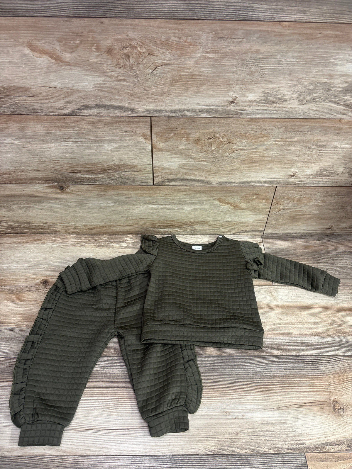 BeMeYourBBs 2pc olive green ruffle sweatshirt and joggers set for infants on a wood background