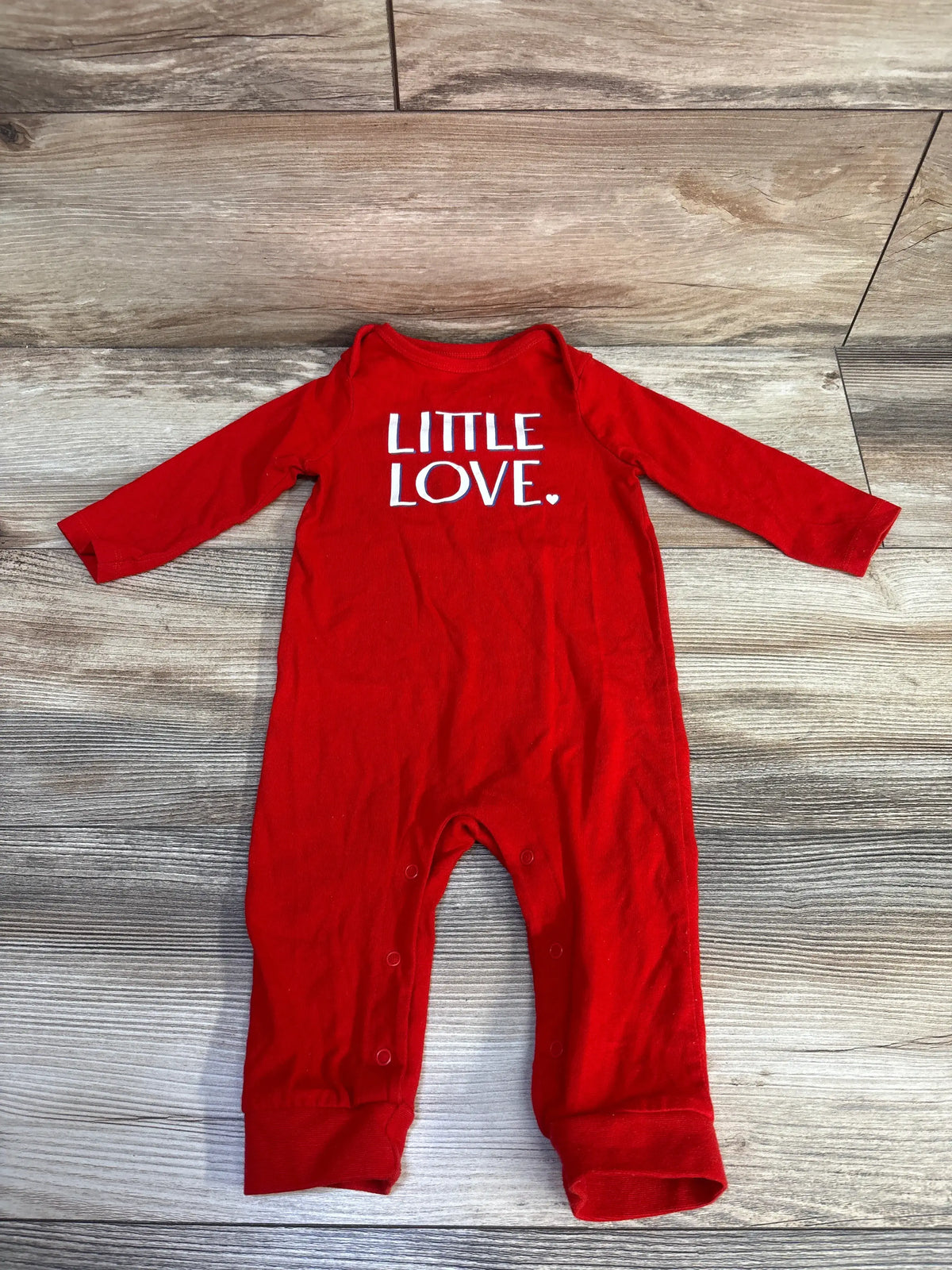 Front view of red Cat & Jack Little Love coverall with long sleeves, snap closures, and LITTLE LOVE text on wood