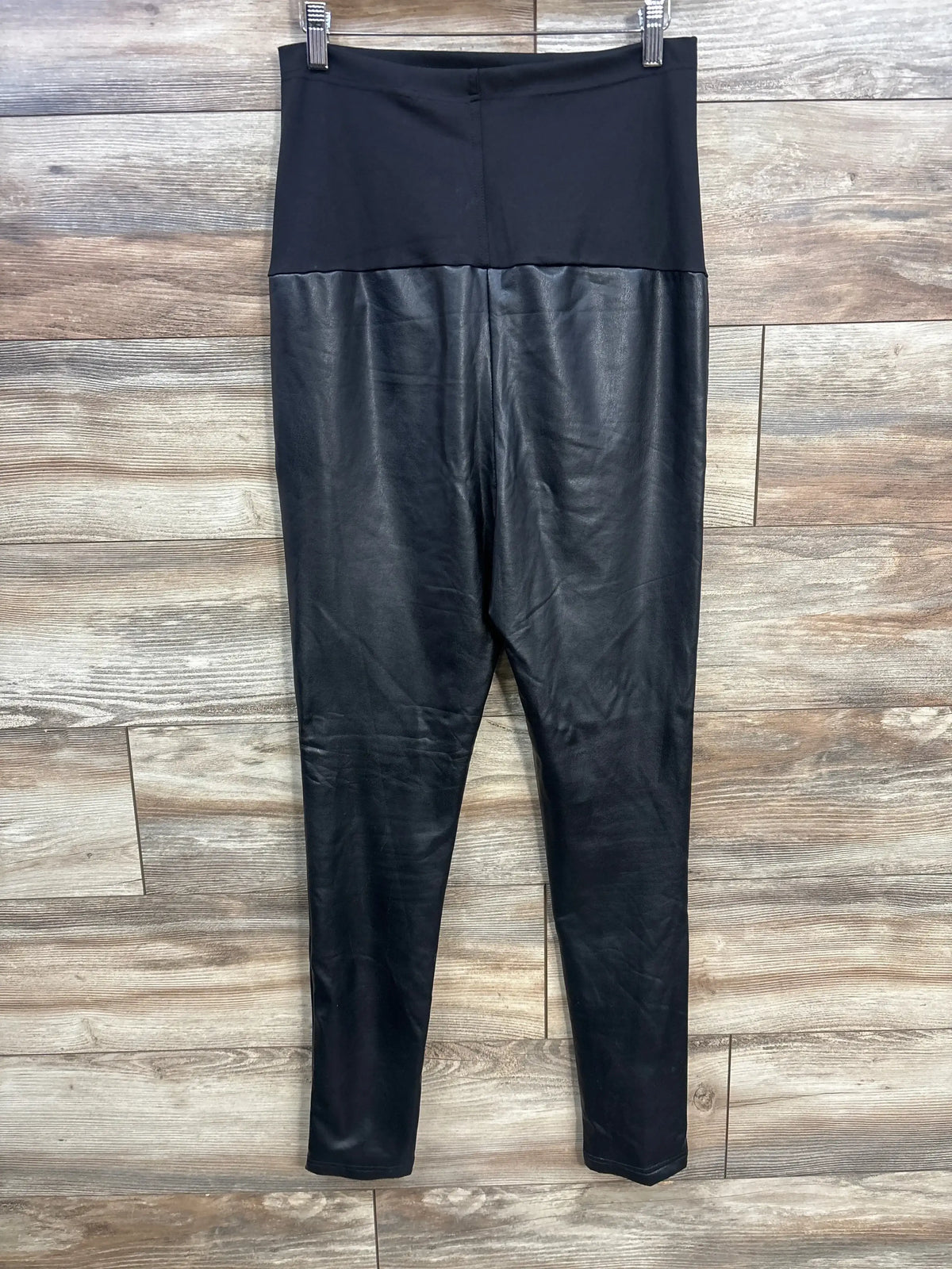 Front view of black Preggo maternity leggings (size XL) showing faux-leather legs and high-waist belly panel on wood background
