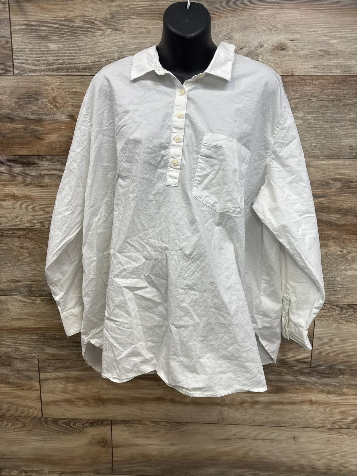Front view of Old Navy maternity henley shirt in white showing three button placket, chest pocket, long sleeves on black mannequin
