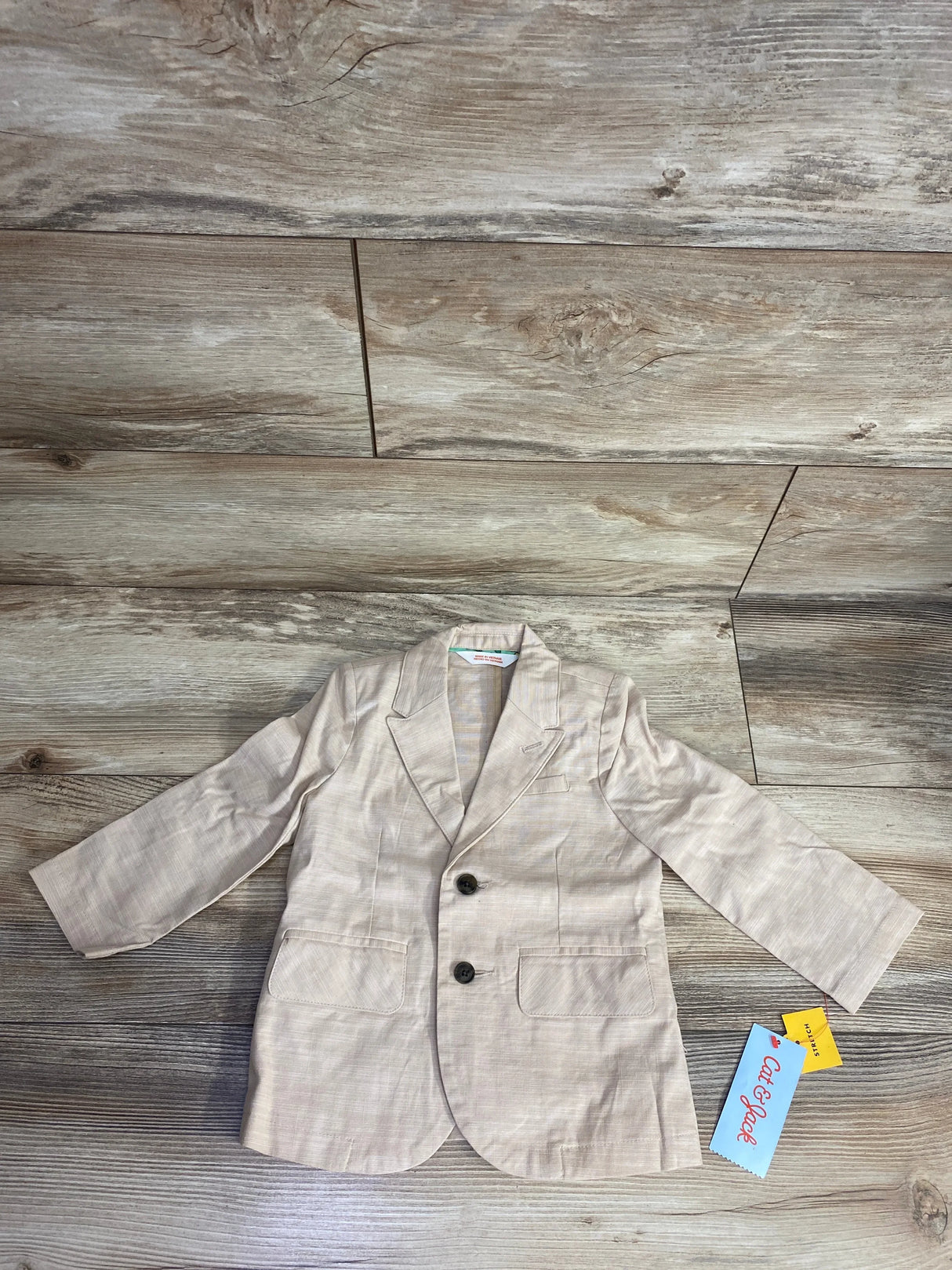 Cat & Jack toddler beige blazer with two buttons and front pockets on wood floor