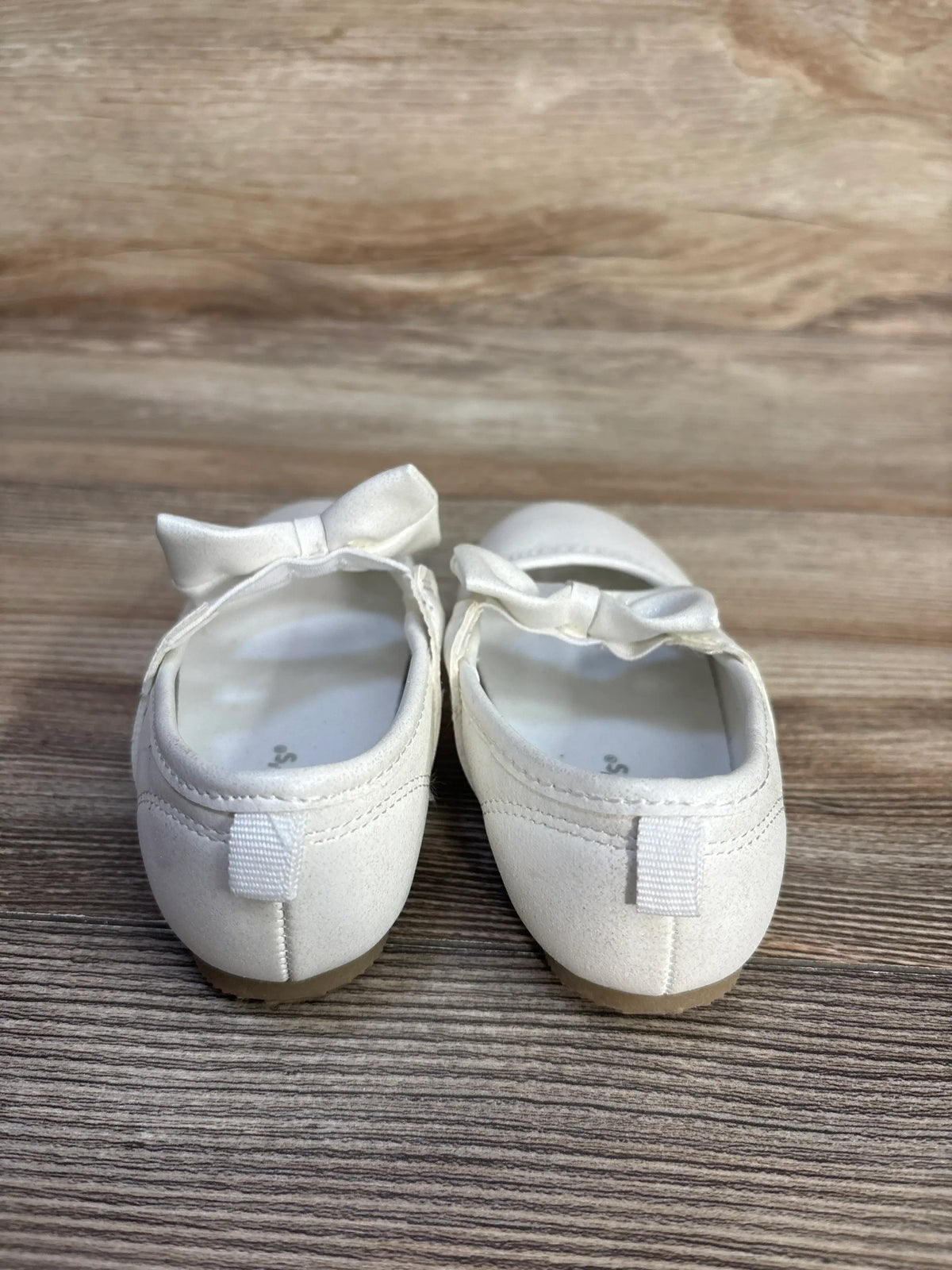Pair of white Me n Mommy To Be classy Mary Jane flats for kids with bow accents.