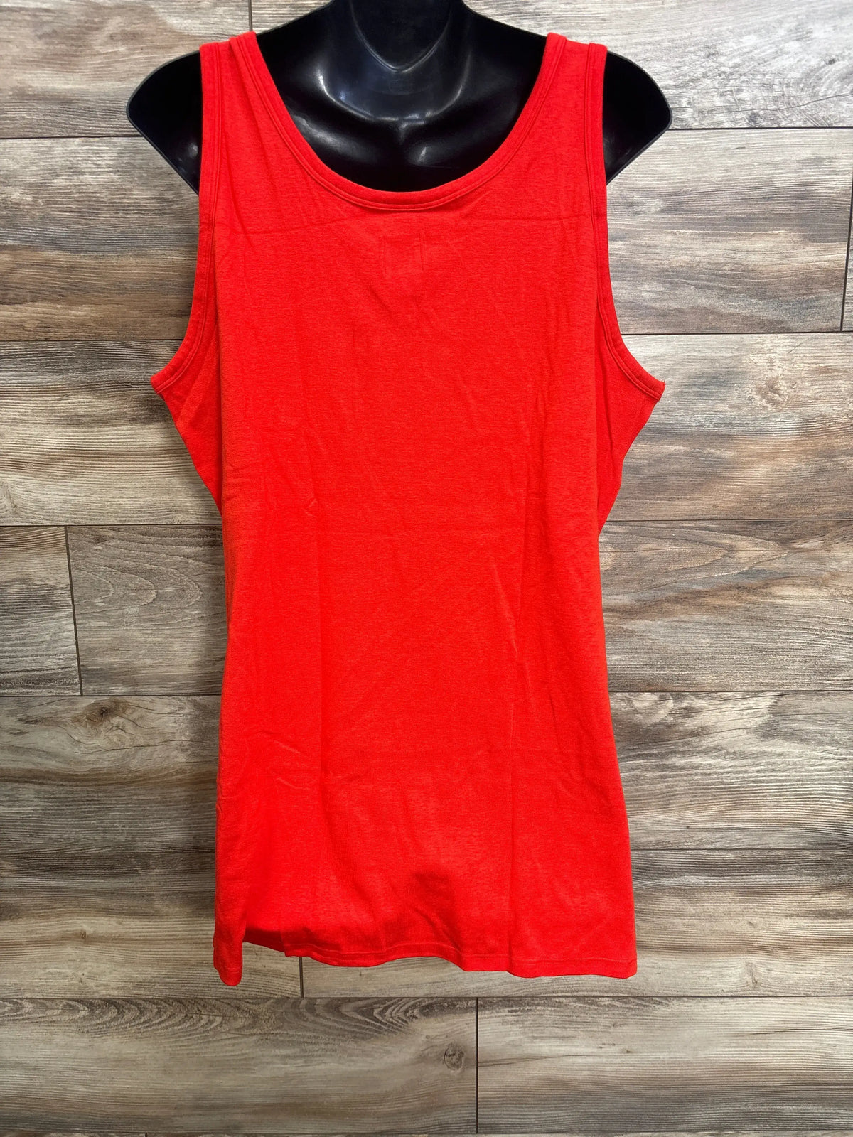 Front view of red Gap Maternity Modern Tank Top showcasing scoopneck and tank straps on a black mannequin over a wood floor
