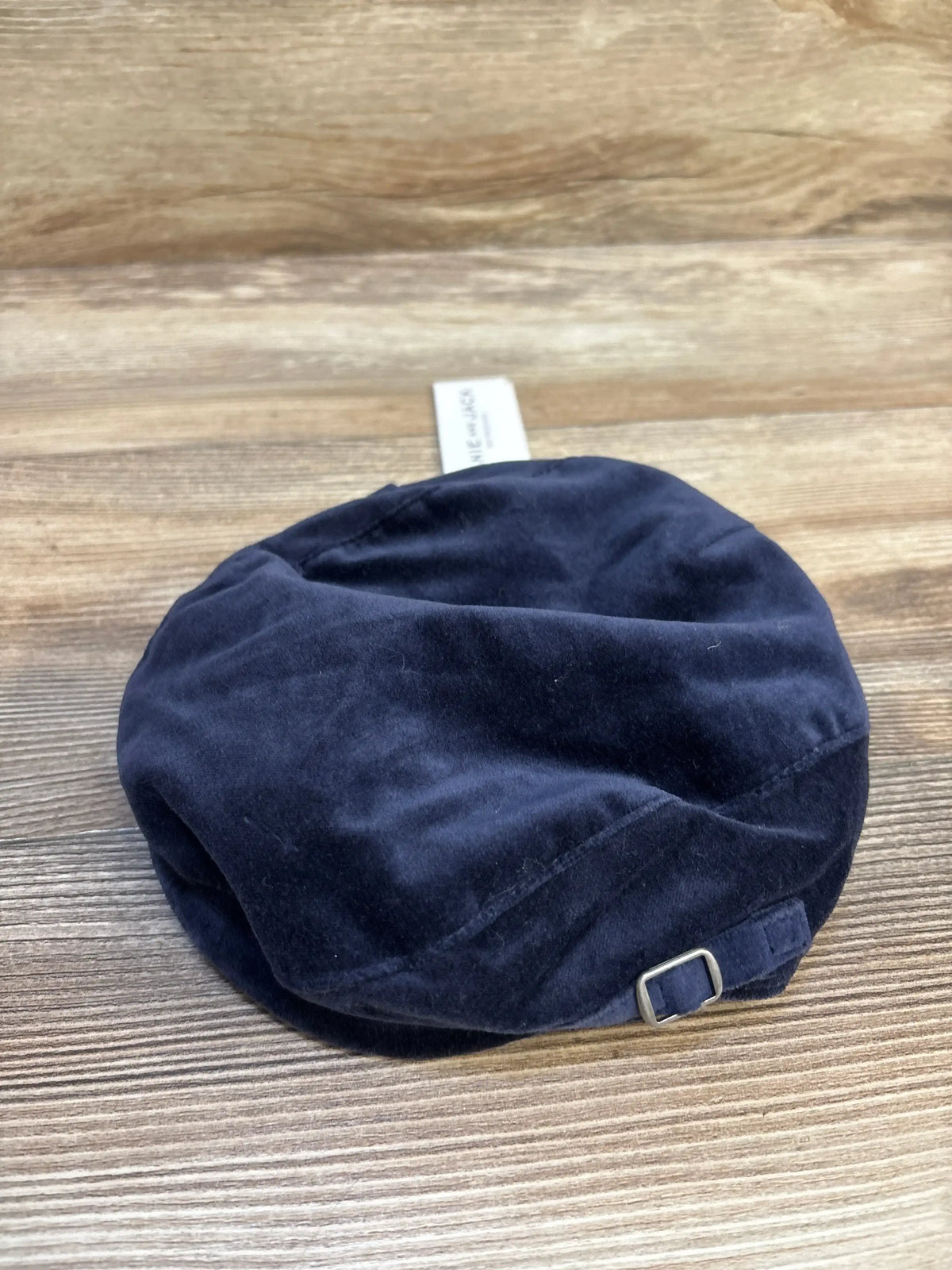 Navy blue velvet kids beret cap with adjustable buckle on wooden background