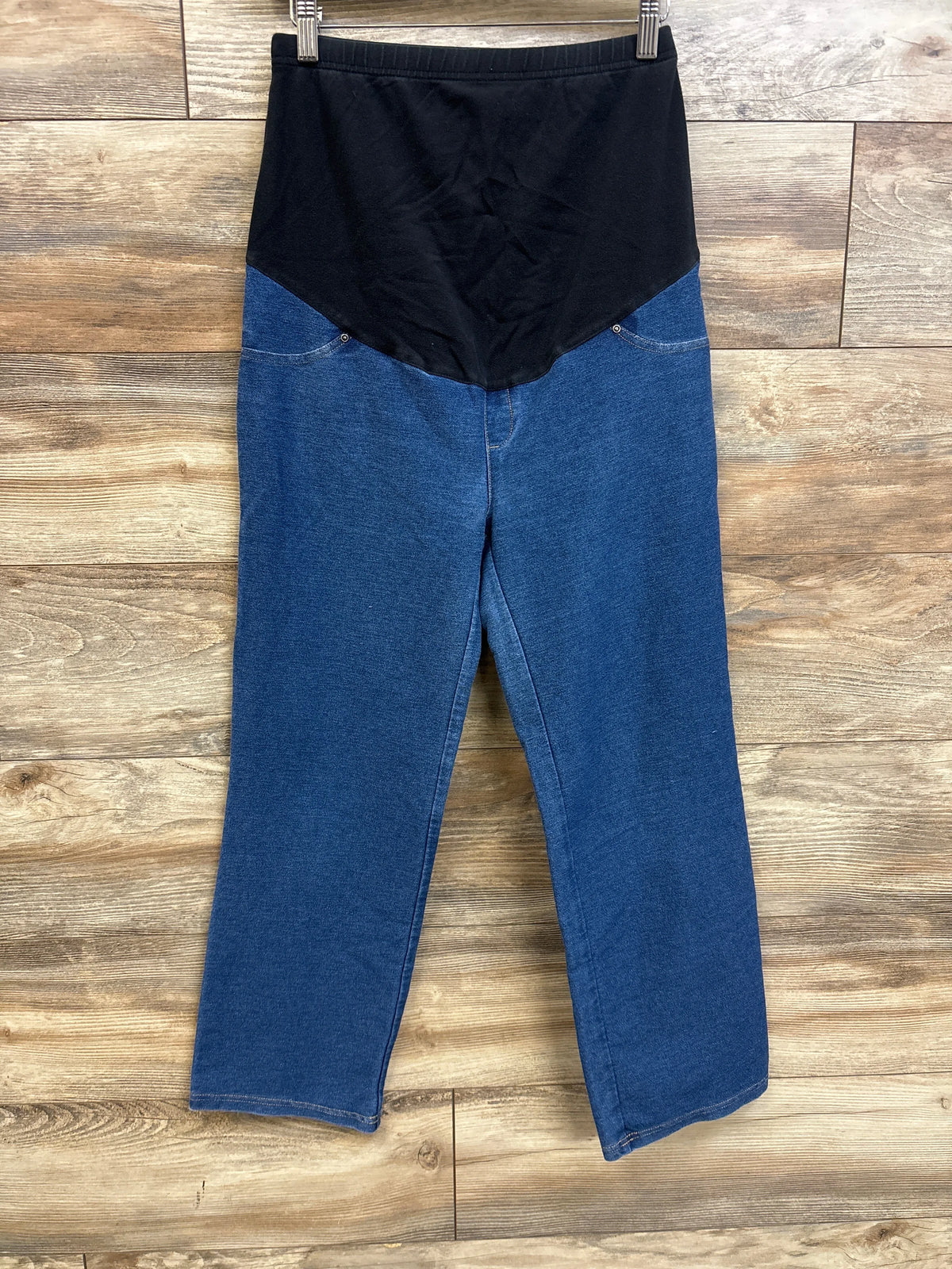 Front view of Time & Tru maternity full panel jeggings showcasing a black full-panel waistband on a wood-look floor