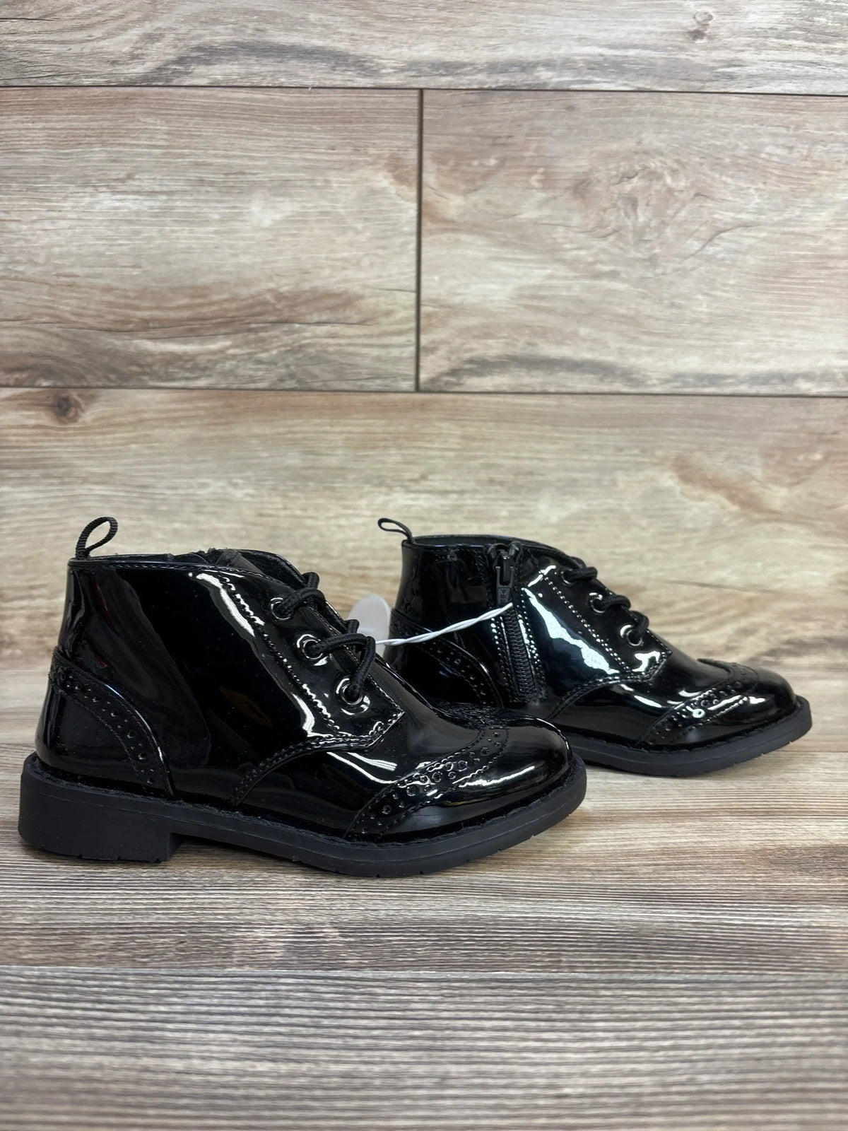 Shiny black patent leather toddler dress shoes with laces and side zipper, perfect for kids' formal wear.