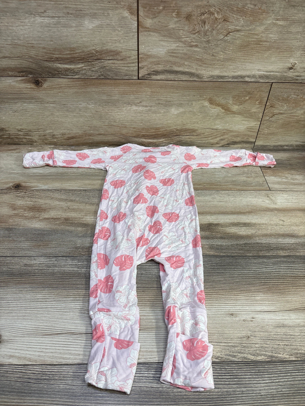 Front view of Georgie’s Corner bamboo convertible sleeper in pink, size 6 to 12 months, with hibiscus and monstera print