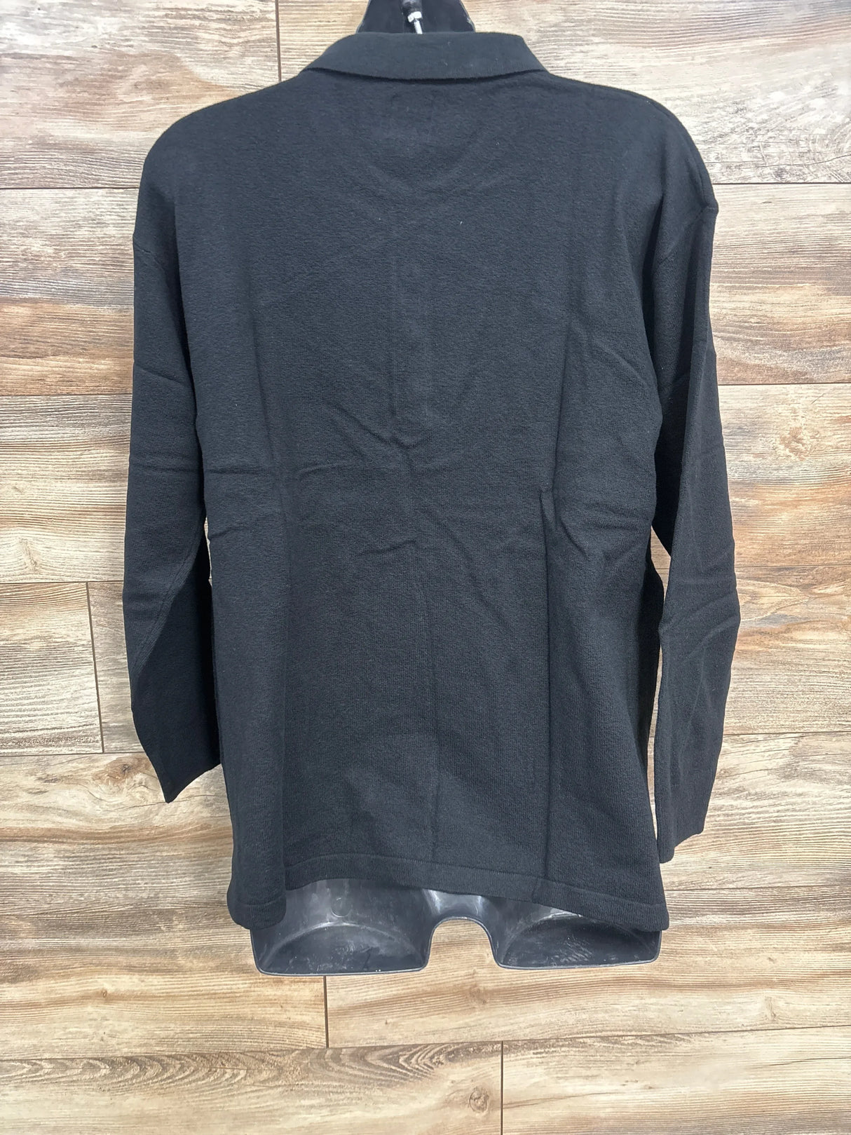 Back view of Gap CashSoft maternity polo sweater in black, size large, showing long sleeves and collar on wood background