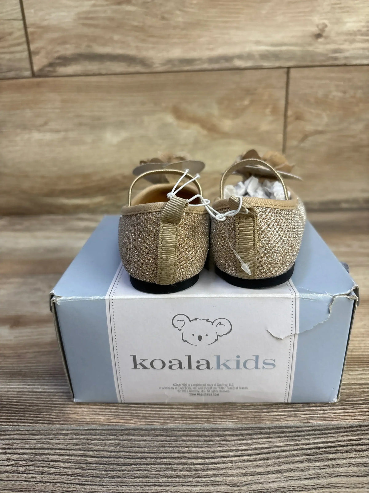 Rear view of Koala Kids gold sparkle Mary Jane flats size 5C showing glitter upper, elastic strap on branded shoe box