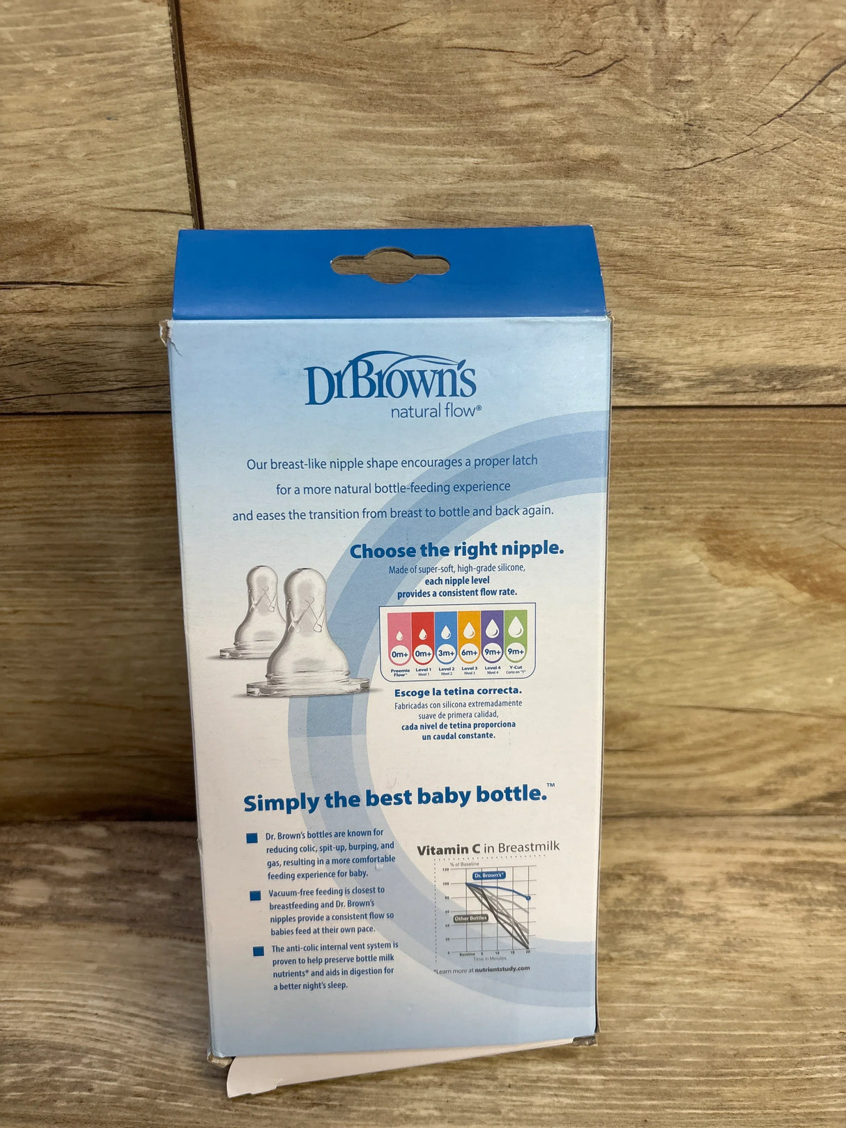 Back of Dr Browns Anti-Colic Narrow Bottles 8oz 2pk box showcasing natural flow nipple info on blue packaging on wood plank floor