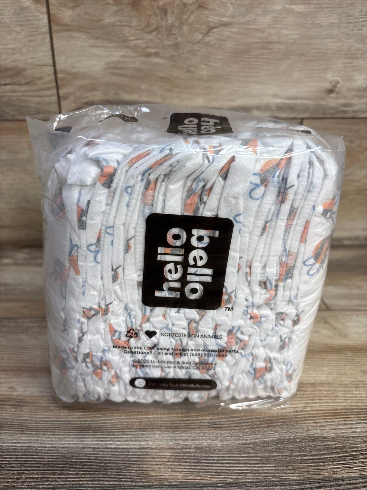 Package of Hello Bello branded diapers with colorful patterns on wooden surface