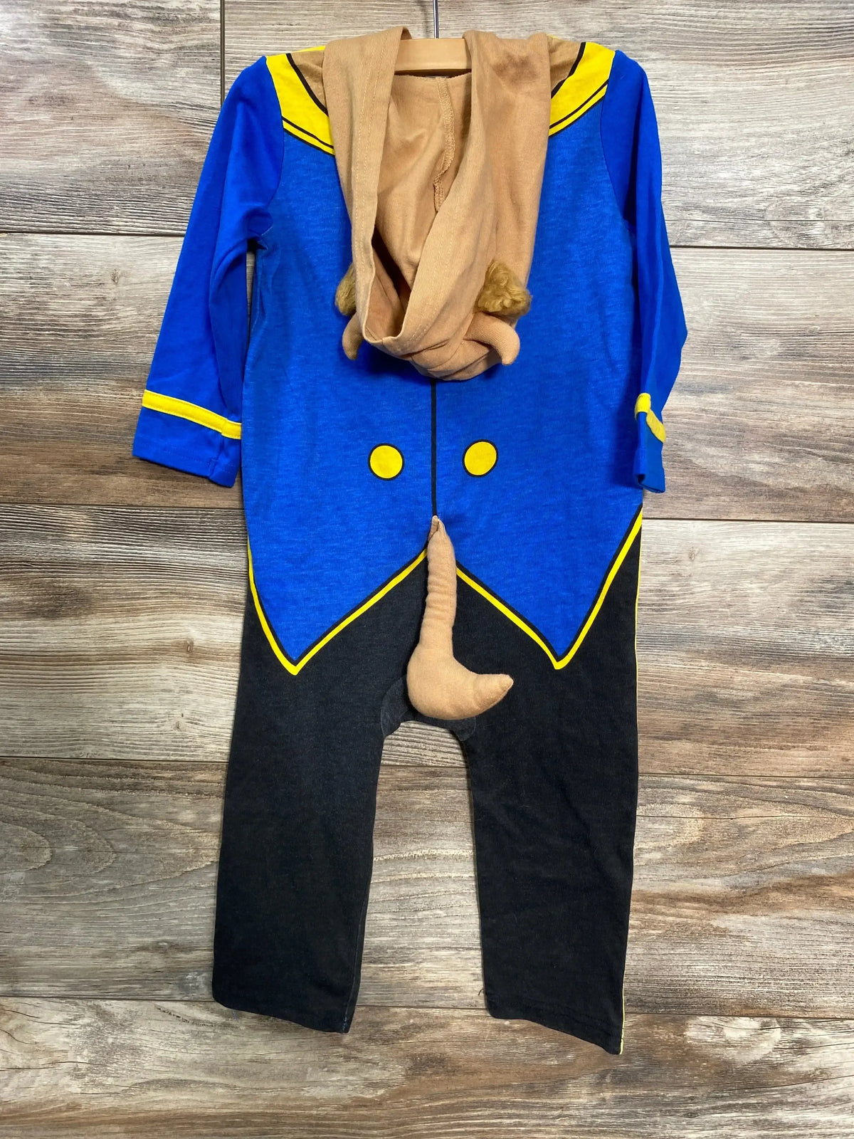 Front view of Beauty and the Beast hooded coverall showing blue top, brown hood with mane and tail on wood floor