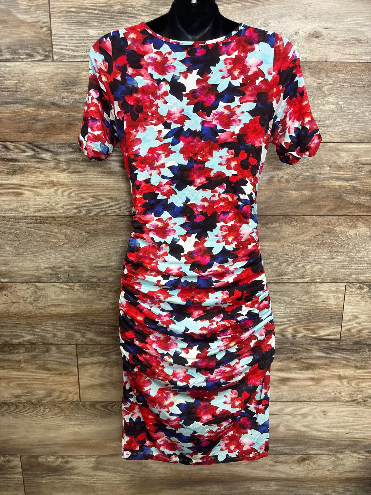 Front view of Isabella Oliver bodycon maternity dress showcasing red floral print, short sleeves, round neck, and ruched sides