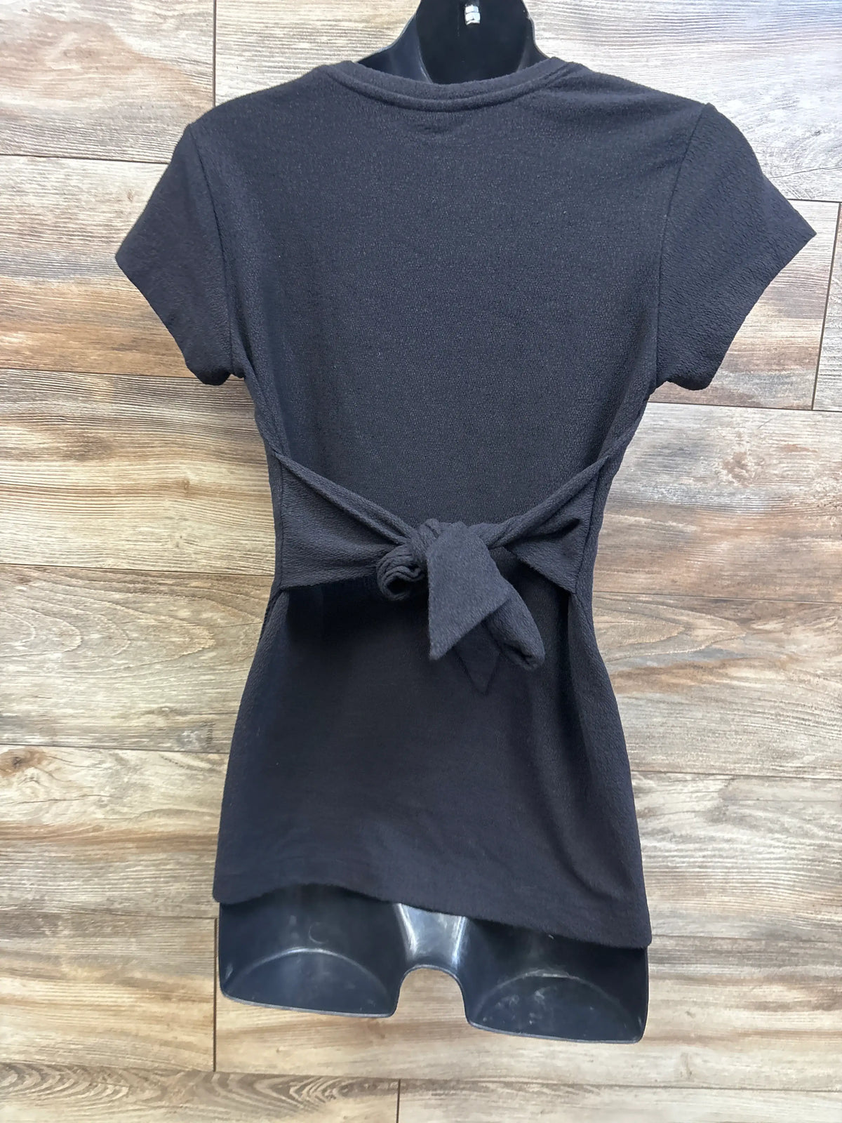 Front view of A Pea In The Pod maternity knit tie top in gray, showcasing short sleeves and front waist tie on a mannequin