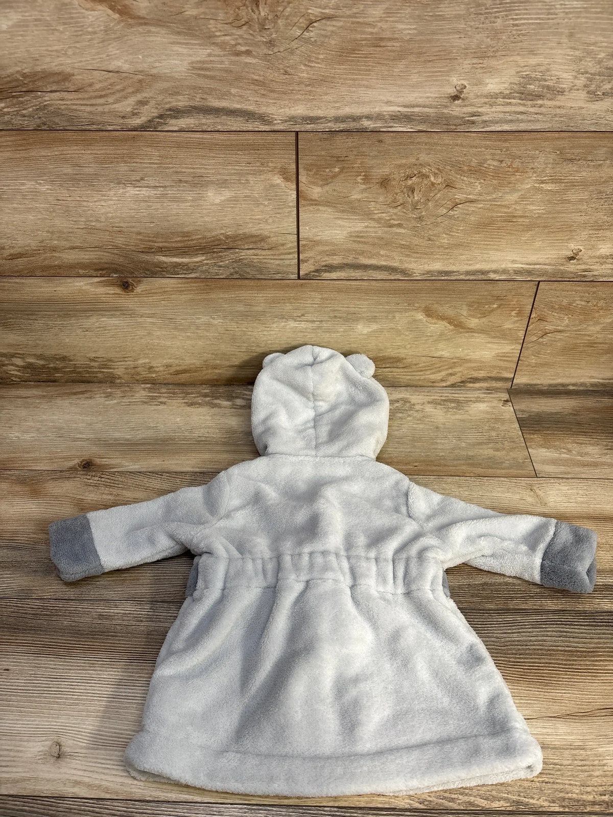 Back view of Cloud Island grey plush bath robe showcasing hood, long sleeves, and waist tie on a wood-look floor