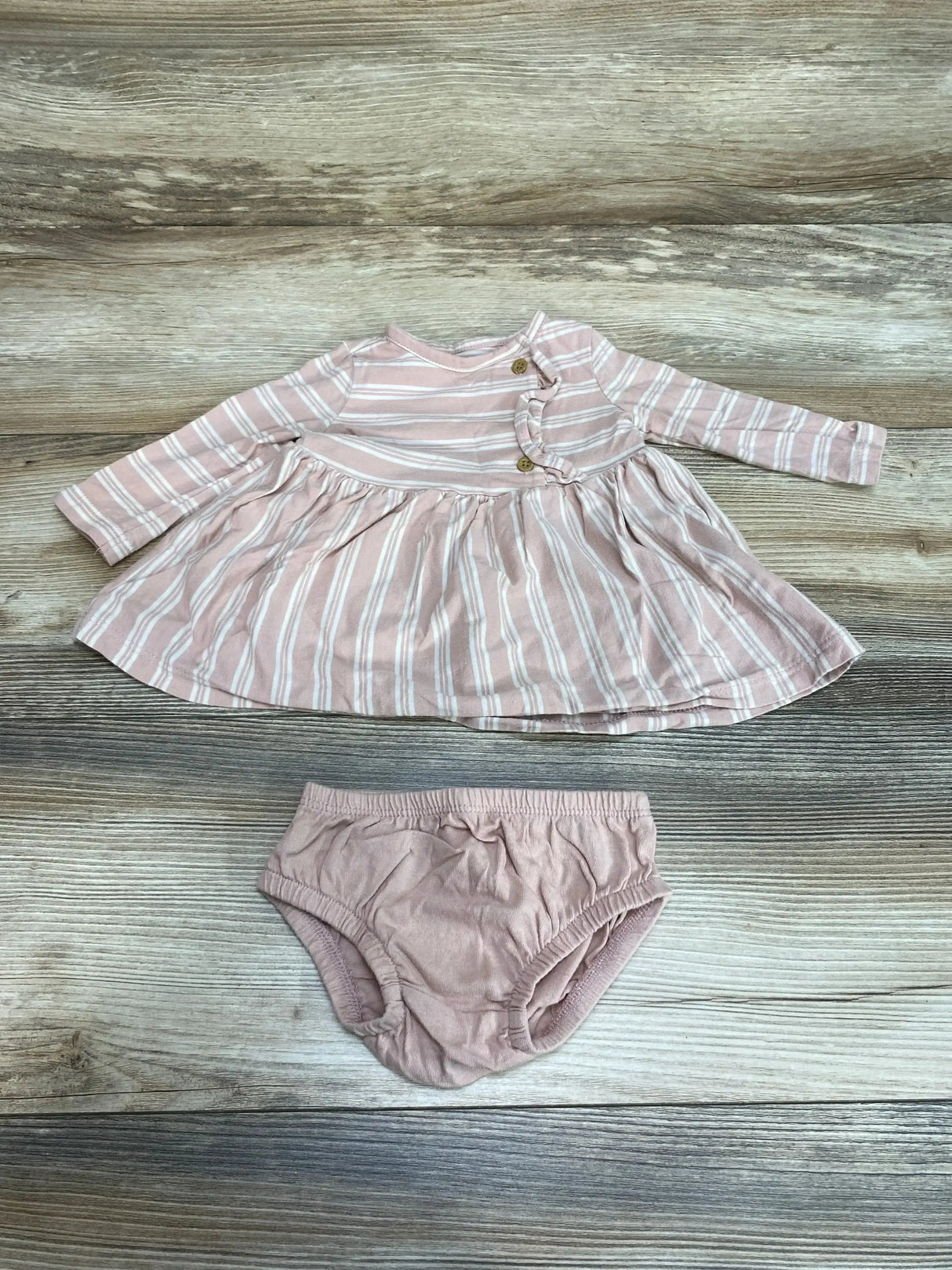 Flat lay of Carters 2pc Striped Dress and Bloomers in pink sz 3m showcasing long sleeve striped dress with matching solid bloomers on wood