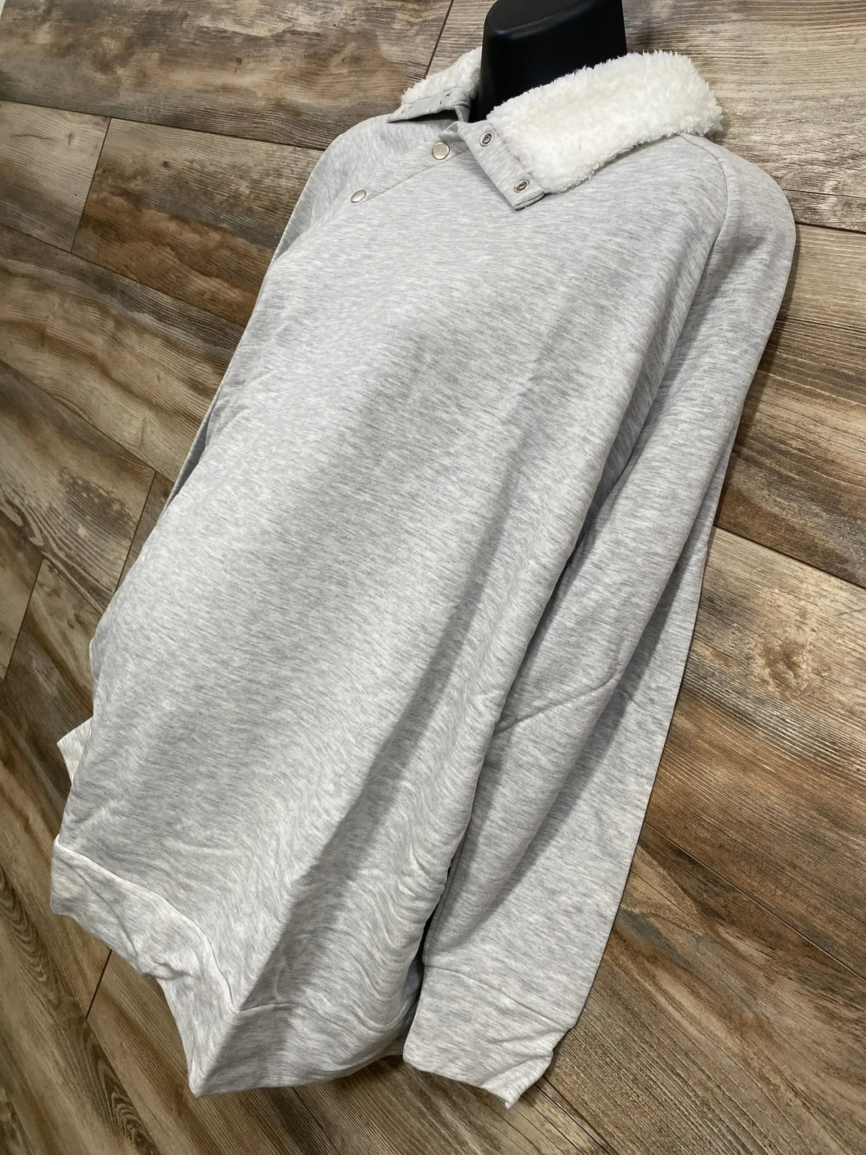 Three quarter front view of Isabel maternity grey sweatshirt showcasing sherpa snap collar and relaxed fit on mannequin