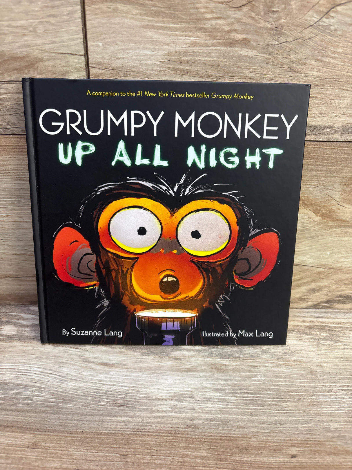 Front cover of Grumpy Monkey Up All Night hardcover featuring a wide-eyed monkey and the title on wood background