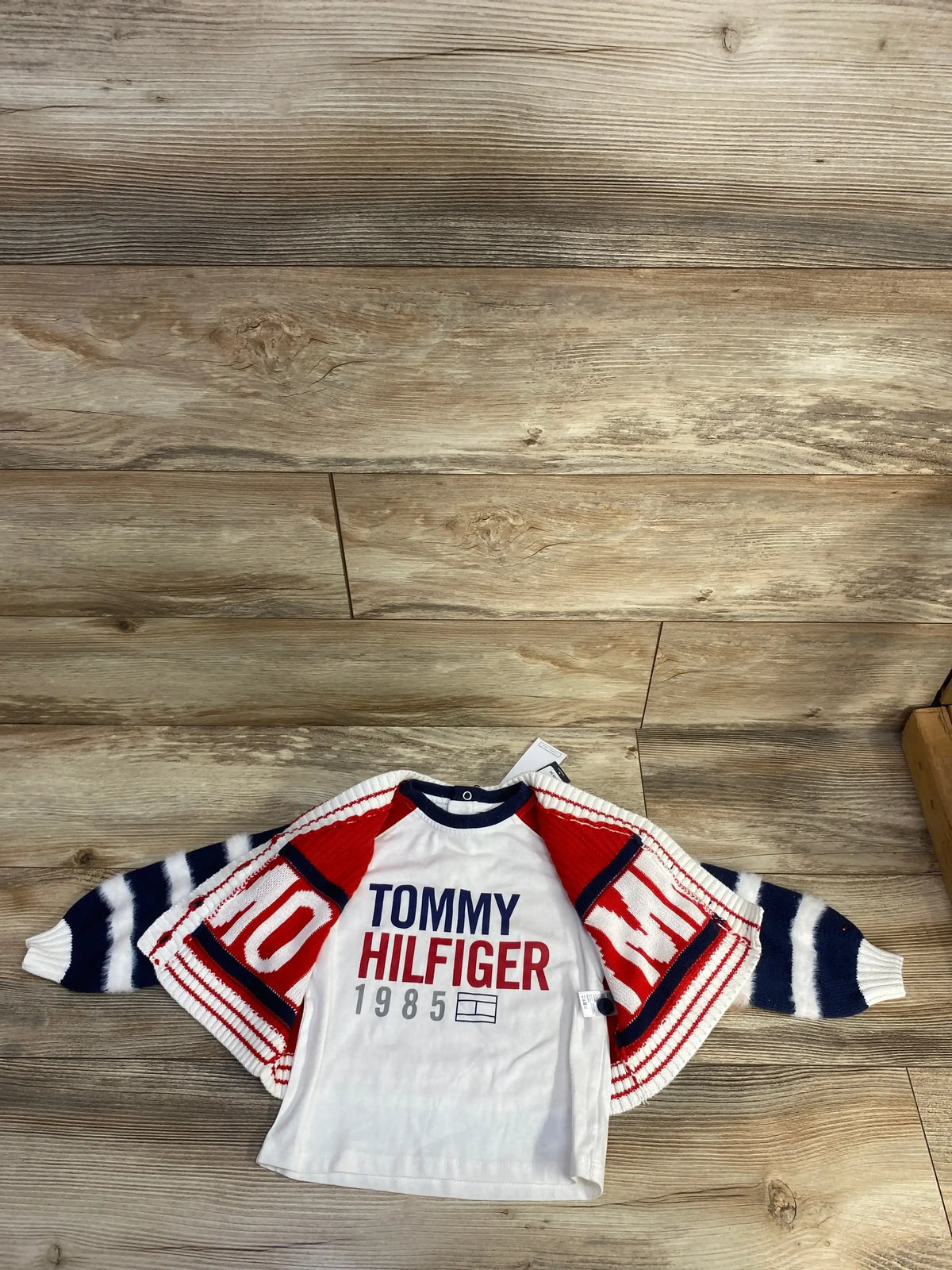 Tommy Hilfiger kids shirt with red, white, and blue cardigan on wood background