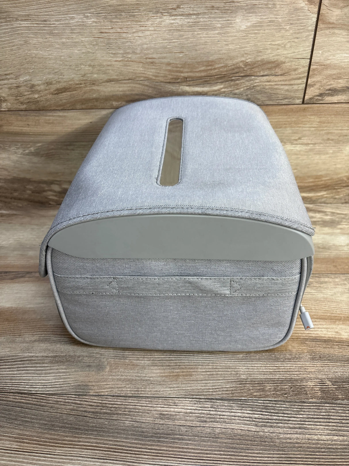 Gray portable baby bottle warmer with zipper case on wood floor
