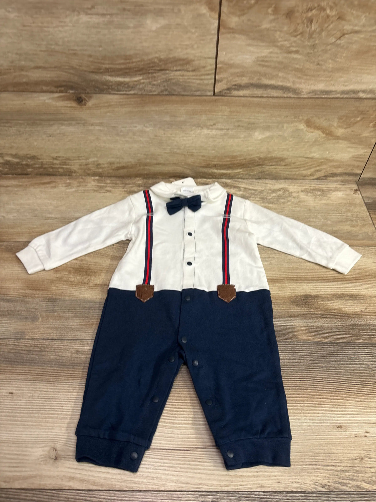 Front view of PatPat Gentleman Suit Coverall showcasing white shirt, navy pants, bow tie, and striped suspenders