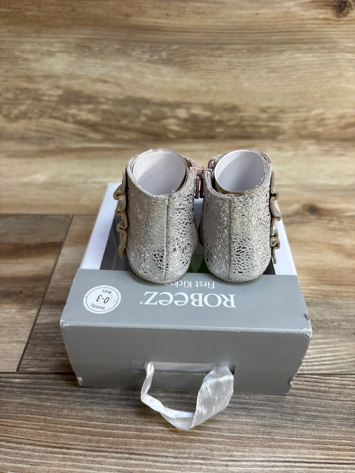 Back view of NEW Robeez First Kicks Madison Boots showcasing silver shimmer textured boots with side zips on original gray Robeez box