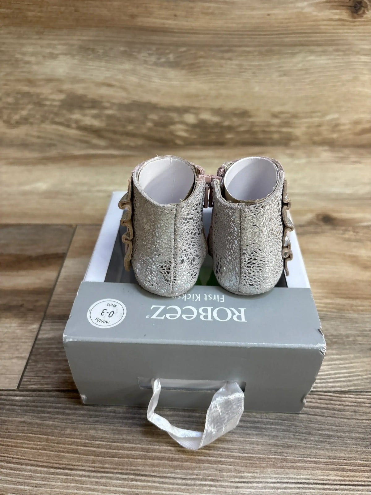 Back view of NEW Robeez First Kicks Madison Boots showcasing silver shimmer textured boots with side zips on original gray Robeez box