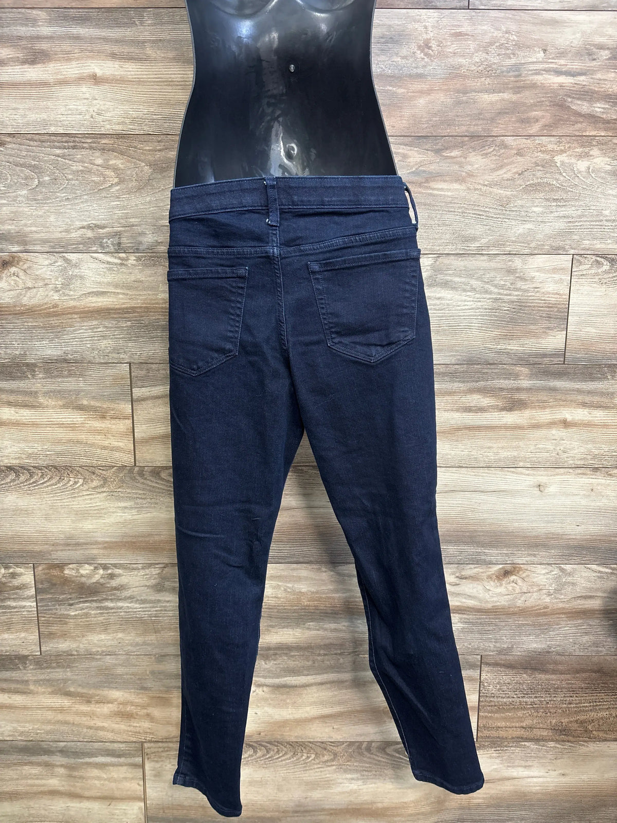 Back view of Isabel Maternity side panel jeggings, size Large, showcasing rear pockets on a wood floor