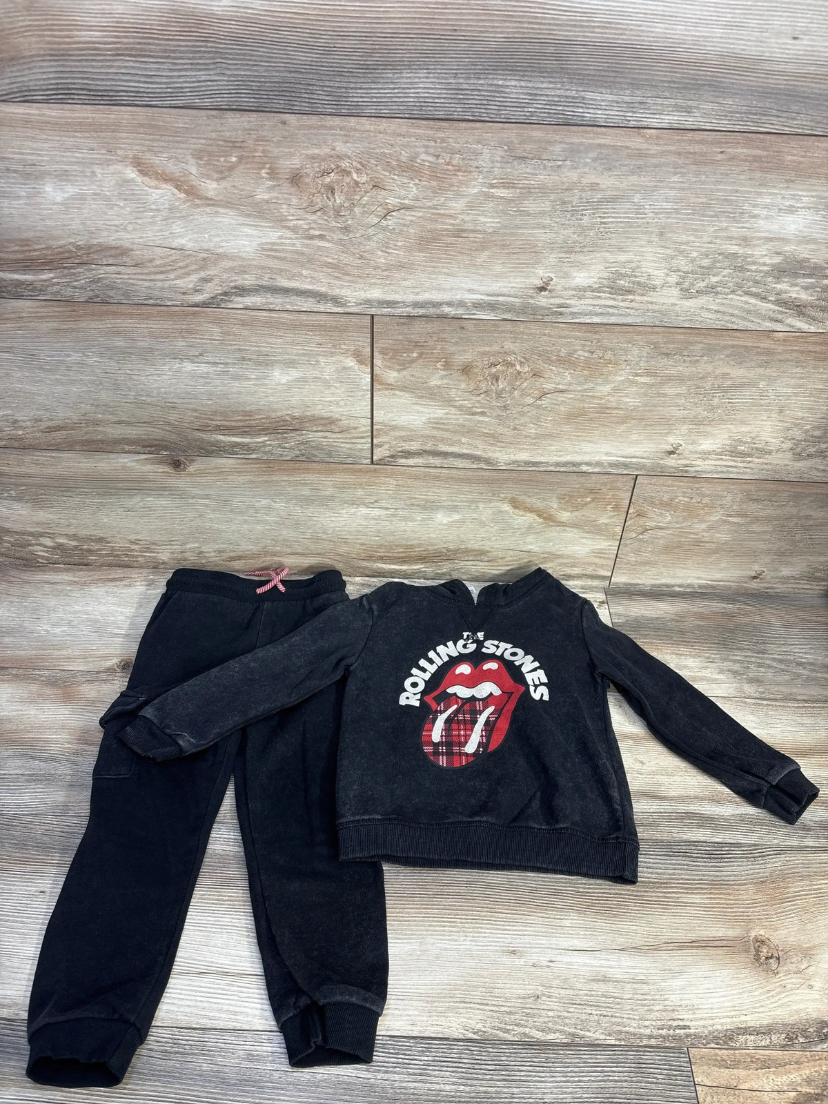 Front view of grey toddler sweatshirt and joggers showing Rolling Stones tongue graphic and elastic waist, on white background