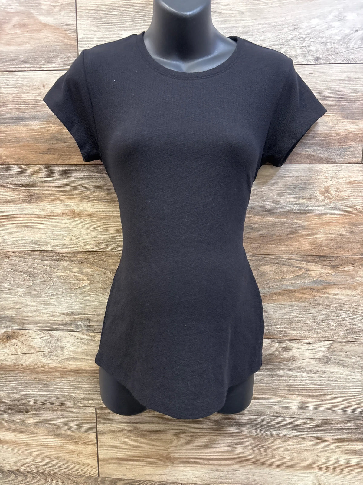Front view of A Pea In The Pod black maternity knit tie top with short sleeves on a mannequin