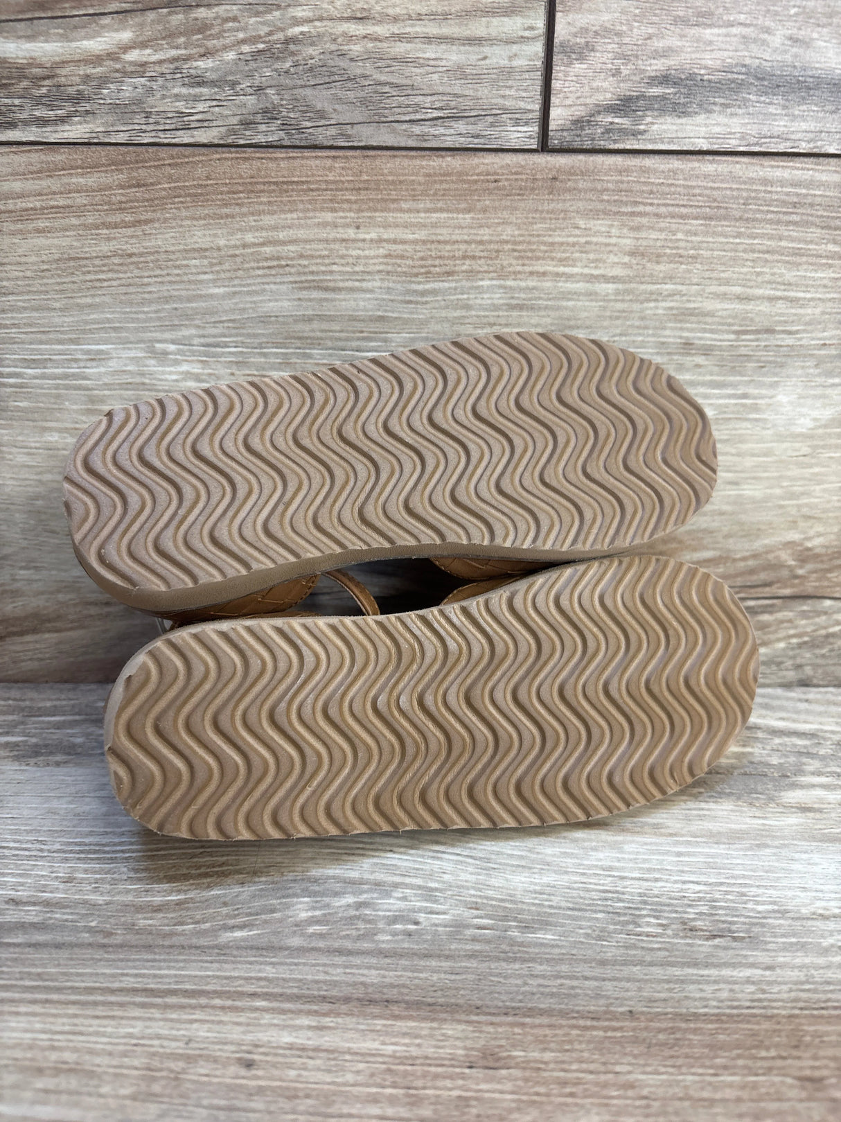 Bottom view of New Old Navy chunky embossed ballet flats size 11C showcasing wavy rubber soles on wooden floor