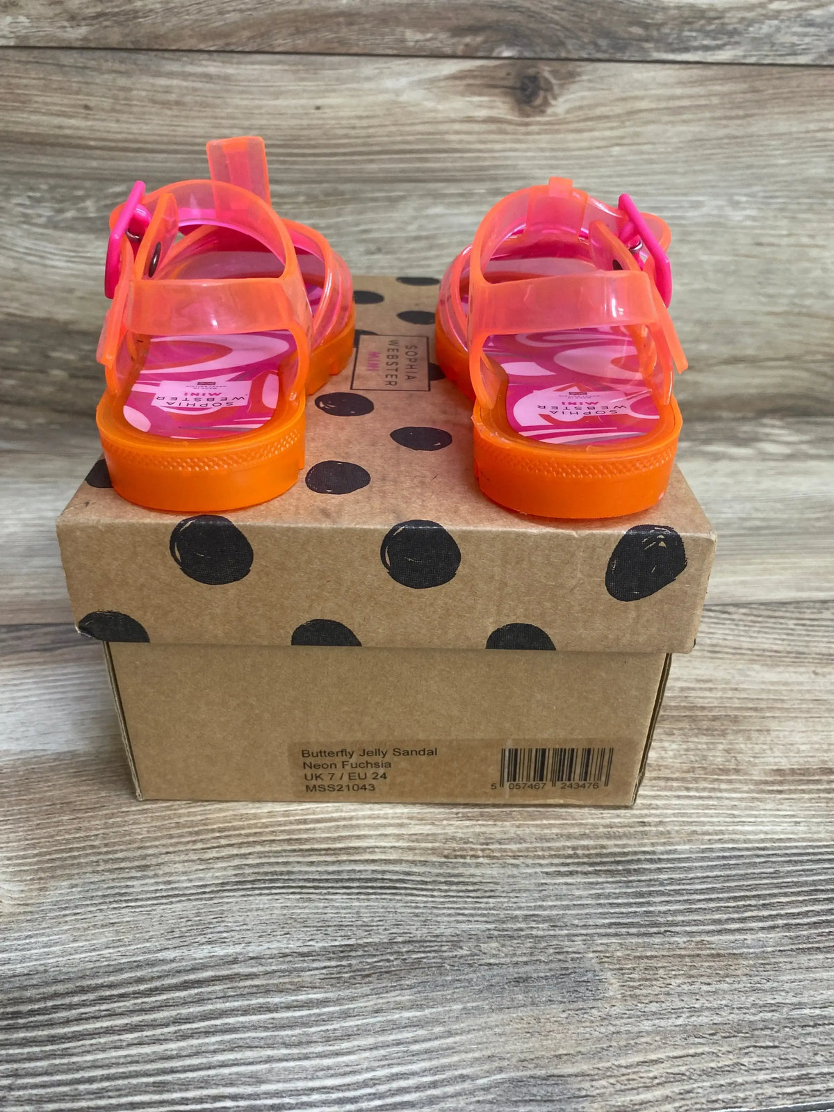 Rear view of Sophia Webster Butterfly Jelly sandals in neon fuchsia with orange soles on polka-dot box, buckle straps, size UK7/EU24