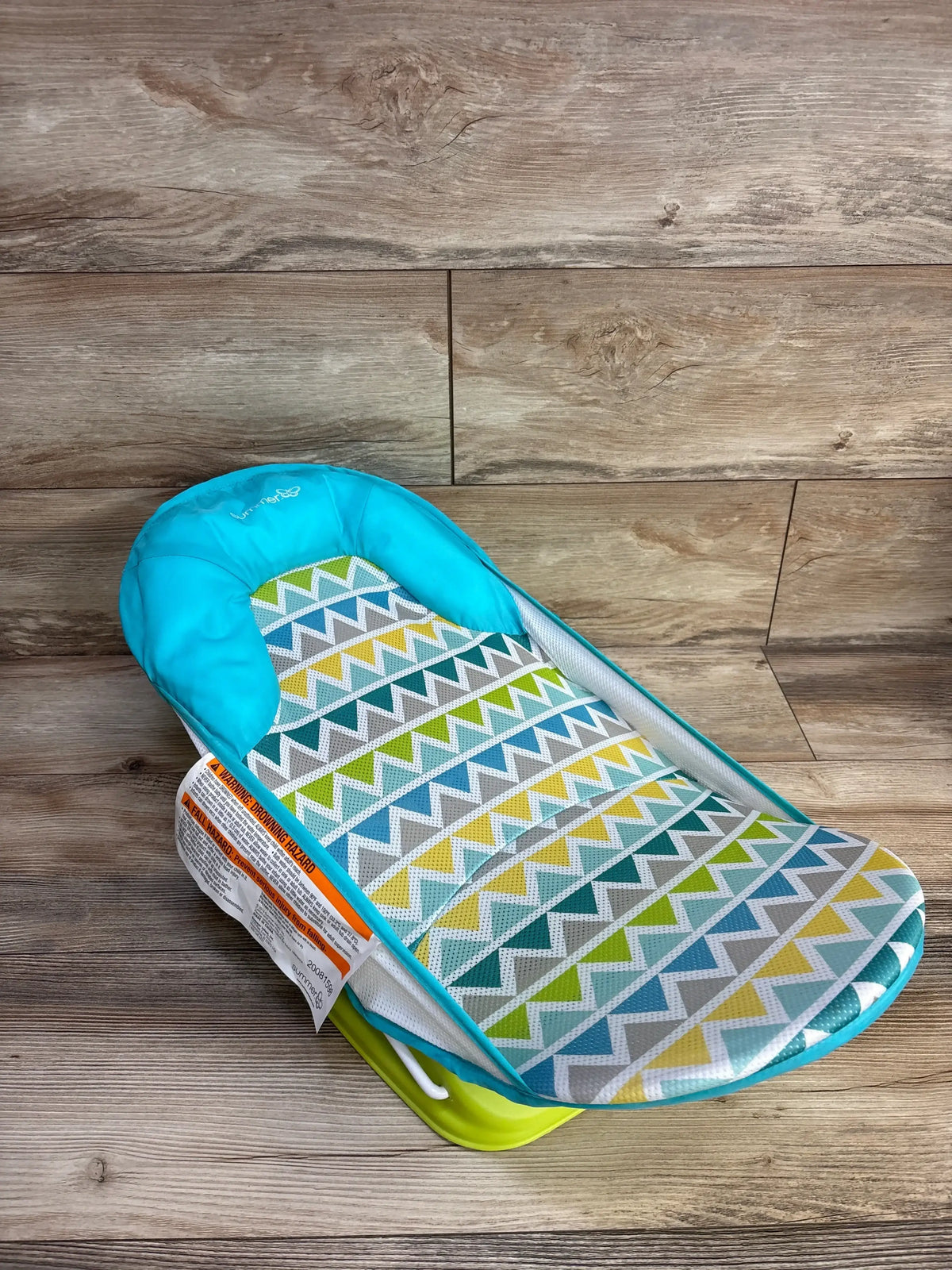 Front view of Summer Deluxe Baby Bather in green showing contoured padded headrest and mesh seat on plain white background