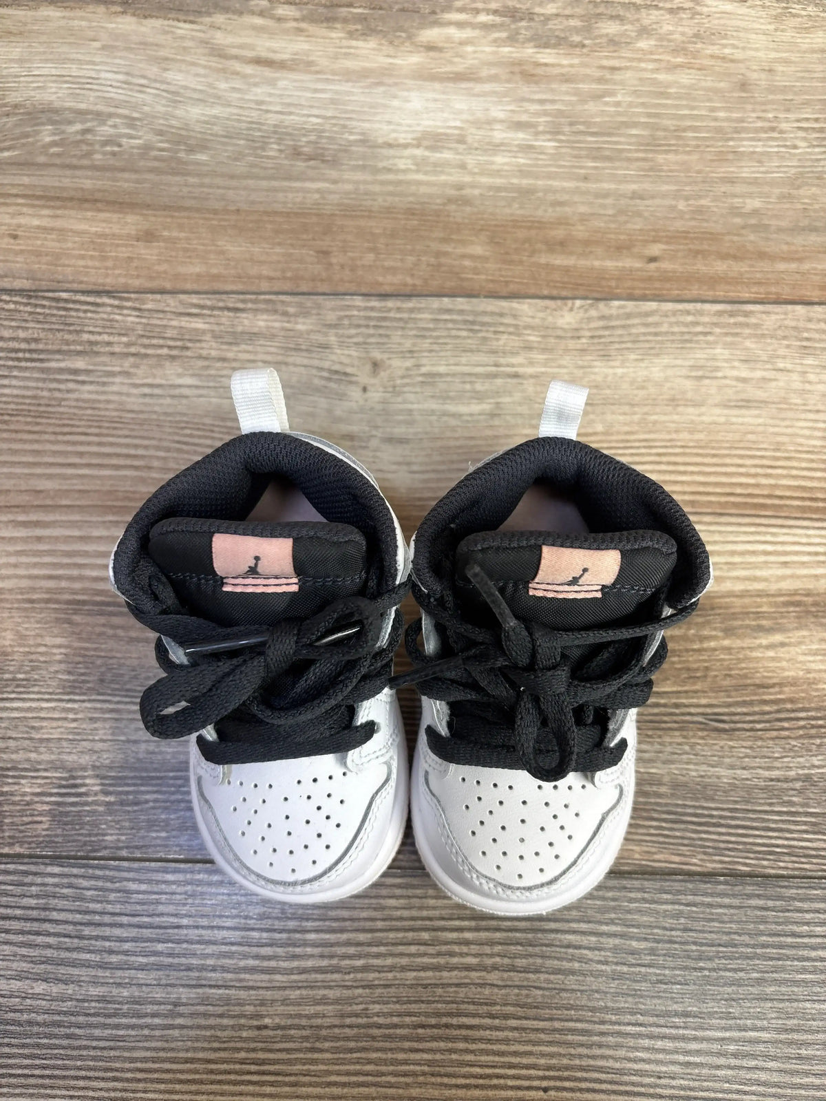Air Jordan 1 Mid TD 'White Arctic Orange' toddler sneakers in size 4c on a wooden floor.