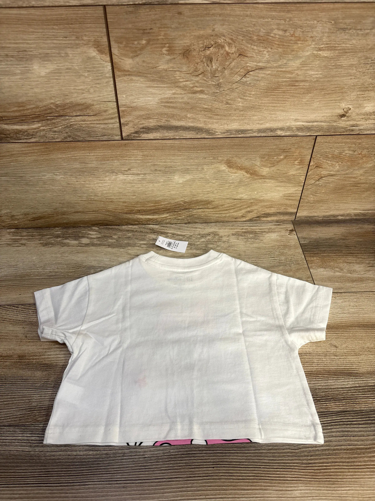 Back view of white Baby Gap x Disney Minnie Mouse graphic T-shirt showing relaxed fit on a wood floor