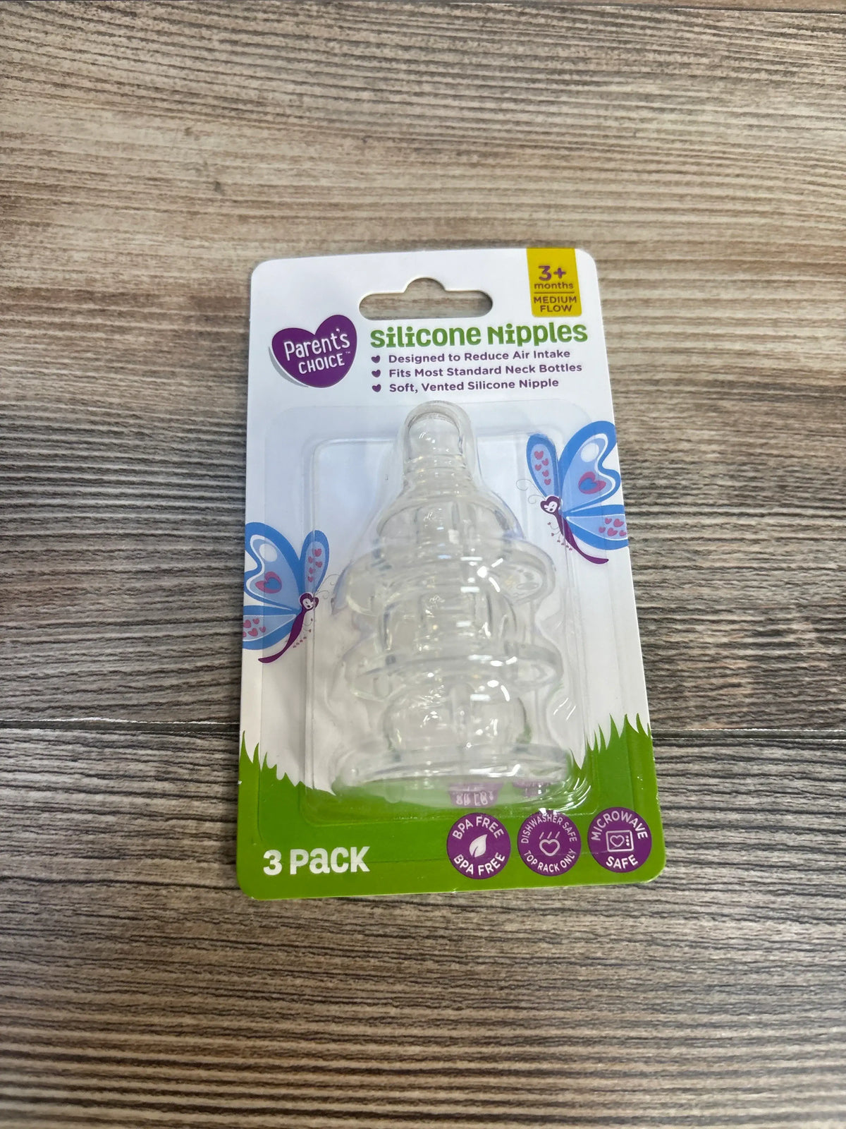 Parent's Choice silicone nipples 3 pack, BPA free, for standard baby bottles, on wood surface.